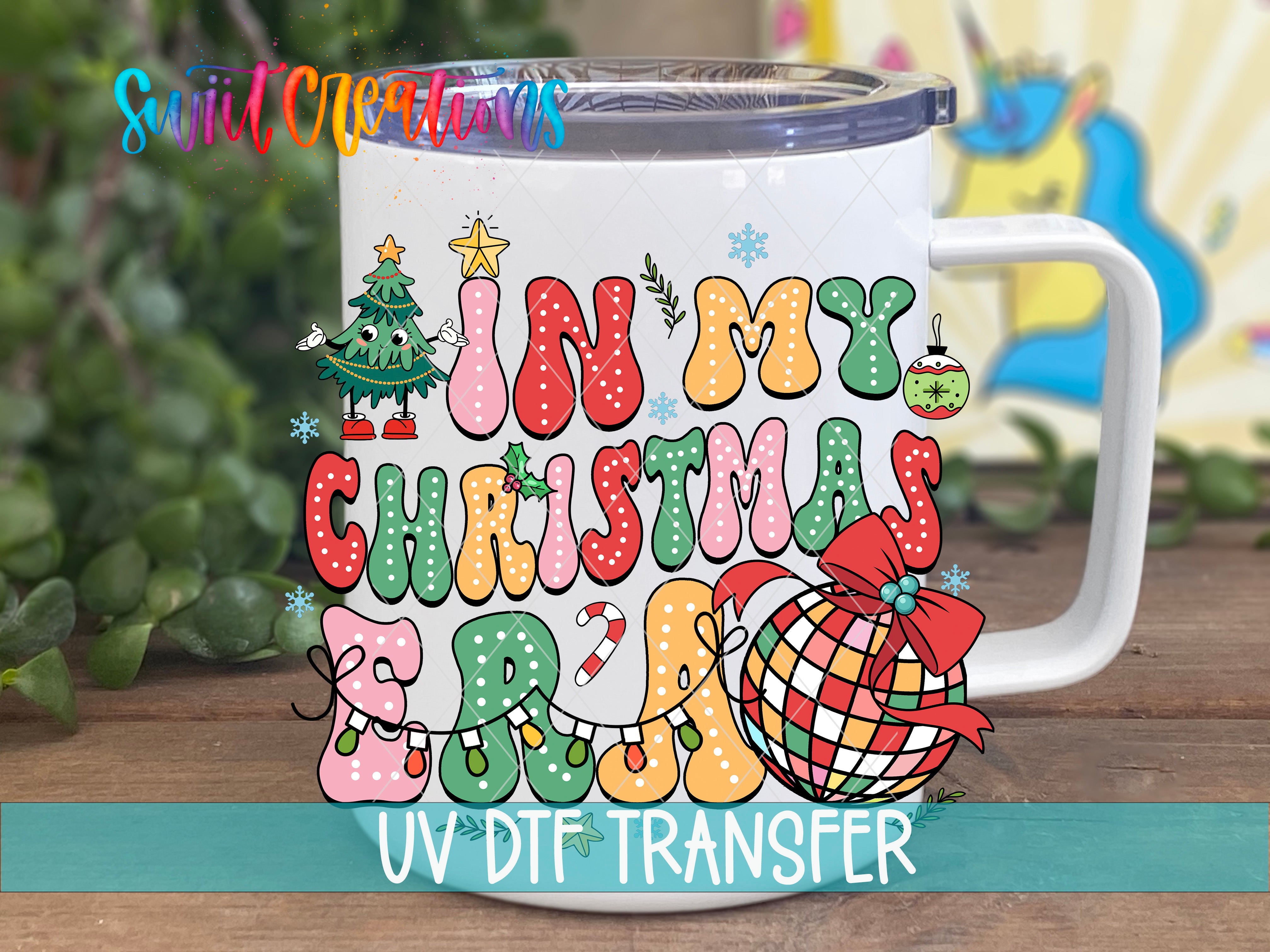A white mug with a colorful, festive design featuring Christmas-themed elements such as a Christmas tree, snowflakes, and a ball.