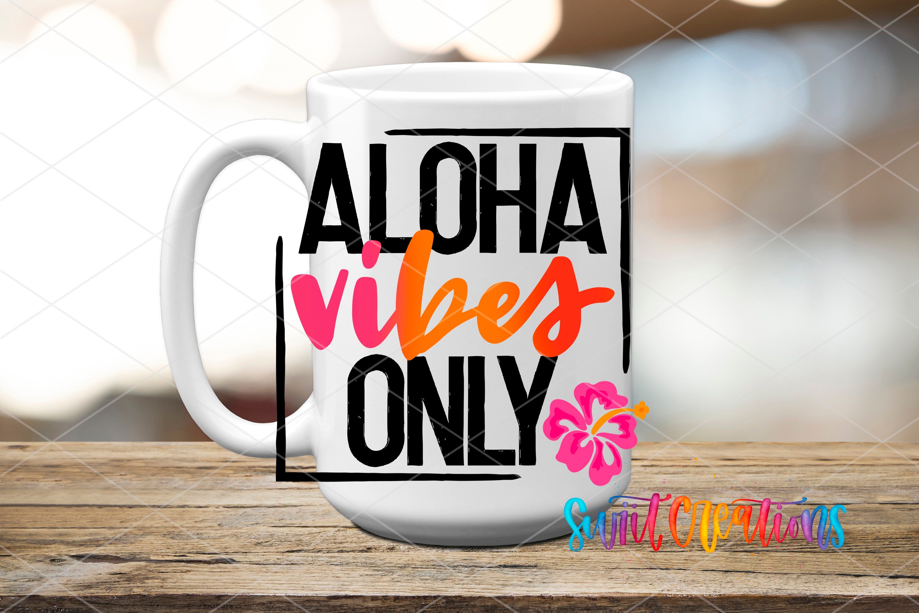 A white mug with the text "ALOHA VIBES ONLY" printed on it, along with a small pink flower design.
