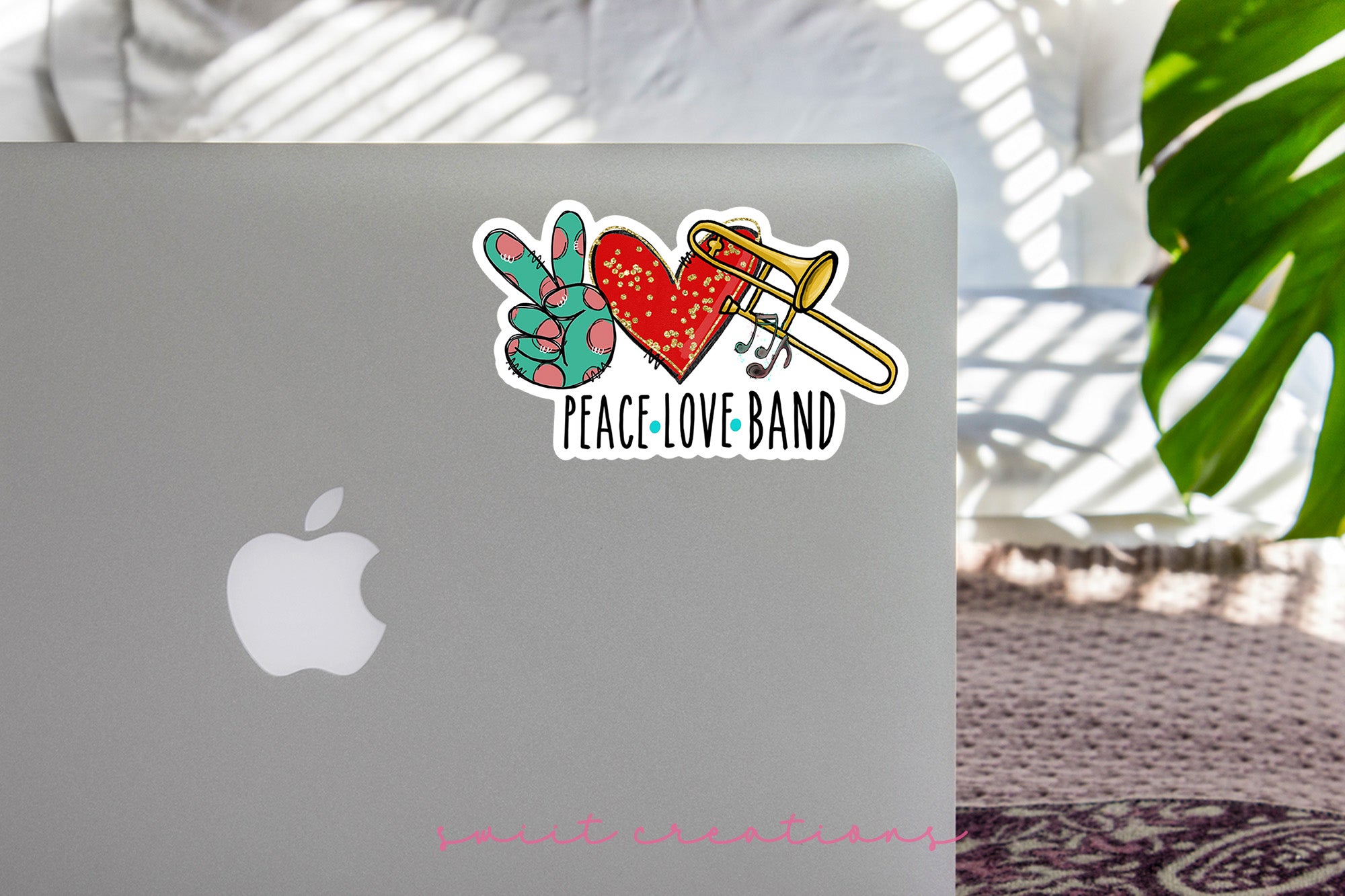 a laptop computer with a sticker of a heart and arrow