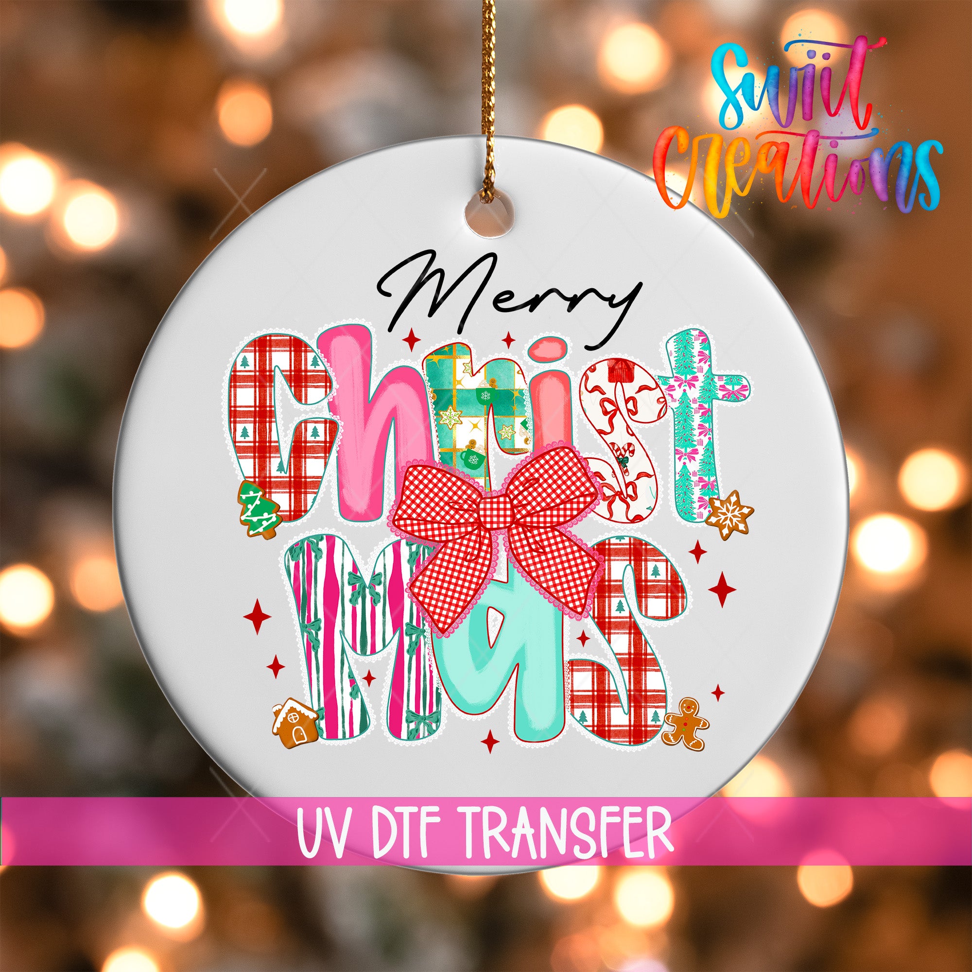 A white ornament with colorful text and decorative elements, including a bow, is hanging against a blurred background with Christmas lights.