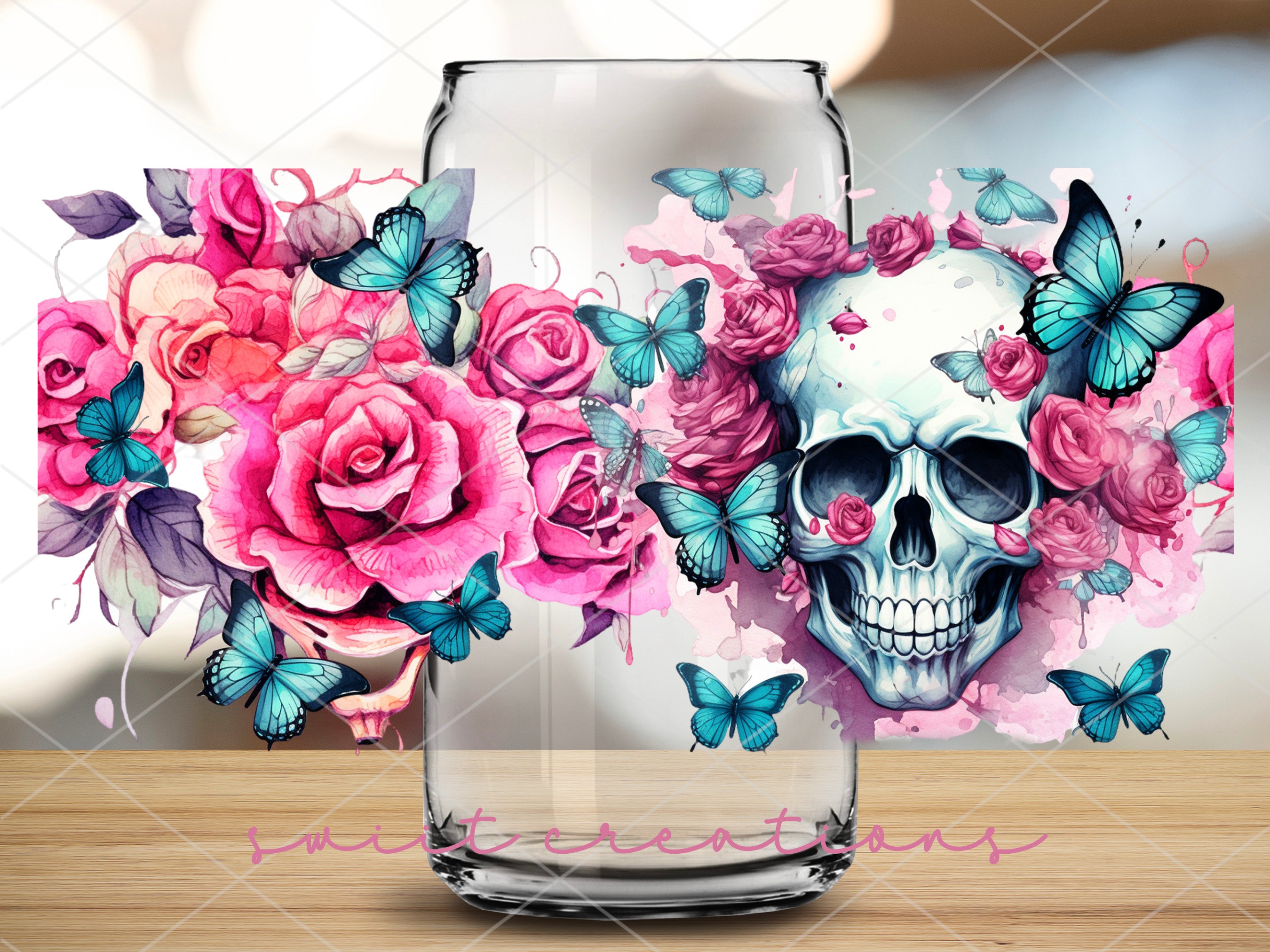 a glass with a skull and flowers on it