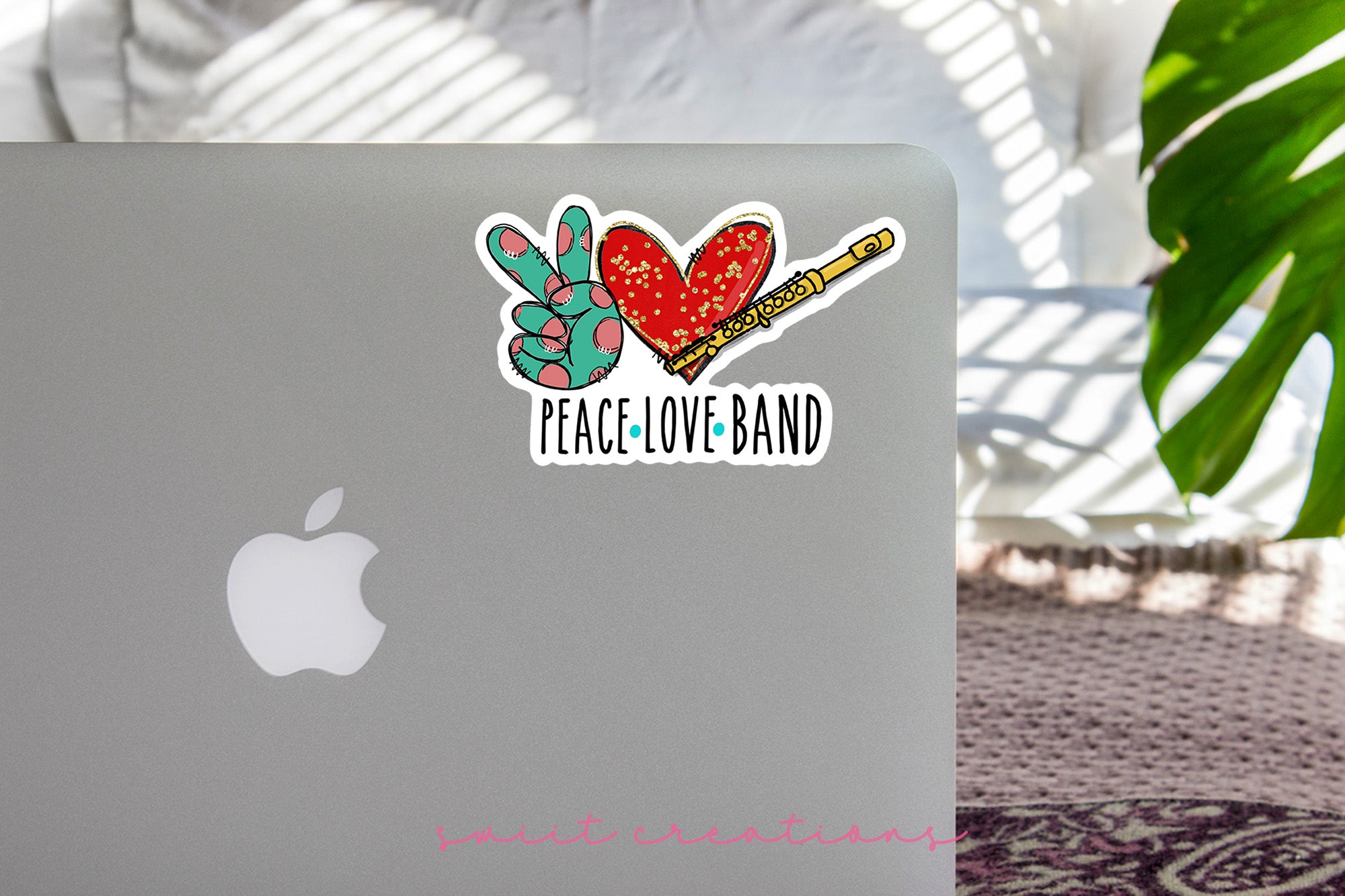a laptop with a peace love band sticker on it