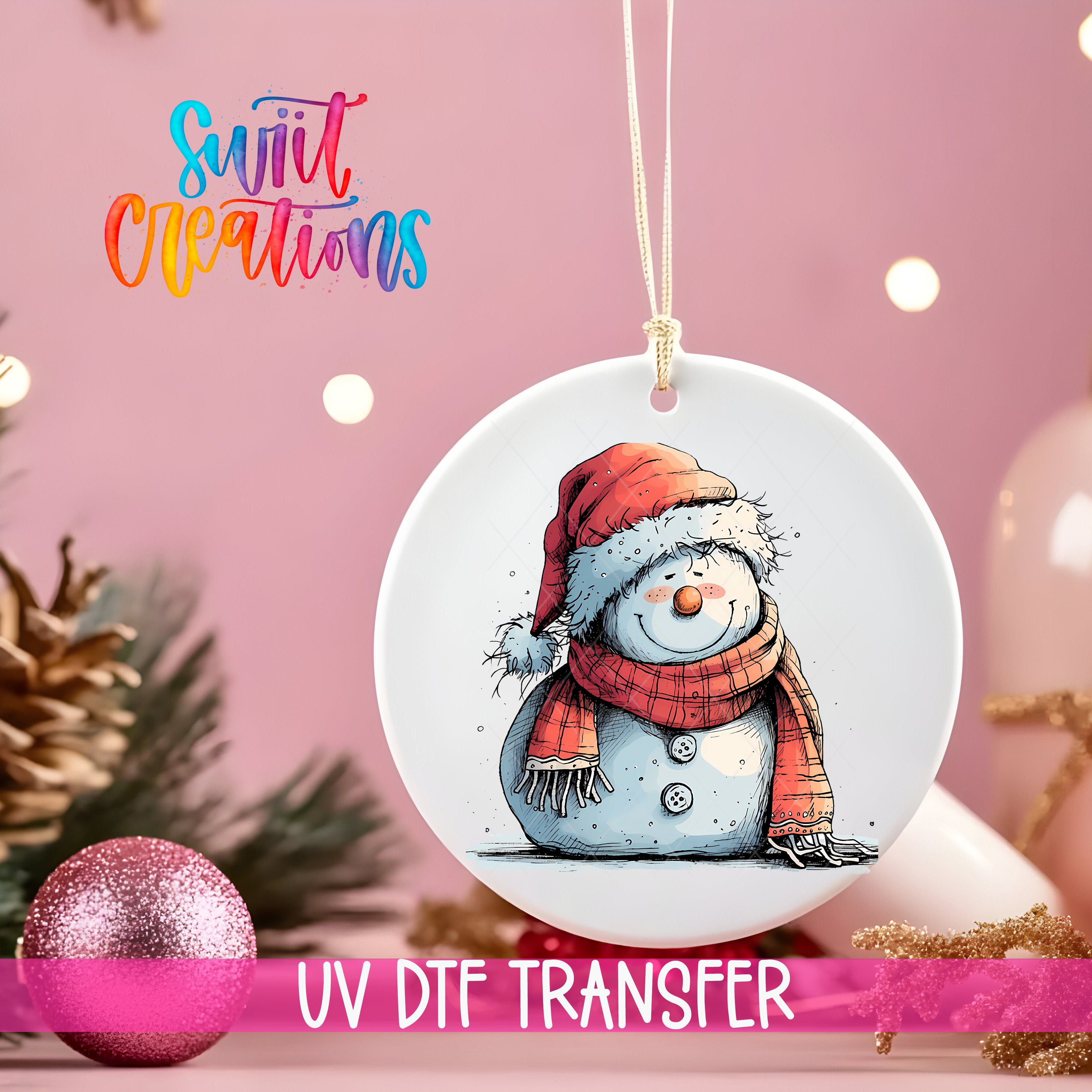 A white ornament with a snowman design hangs against a pink background, with a pink glitter ball and pine cones in the foreground.