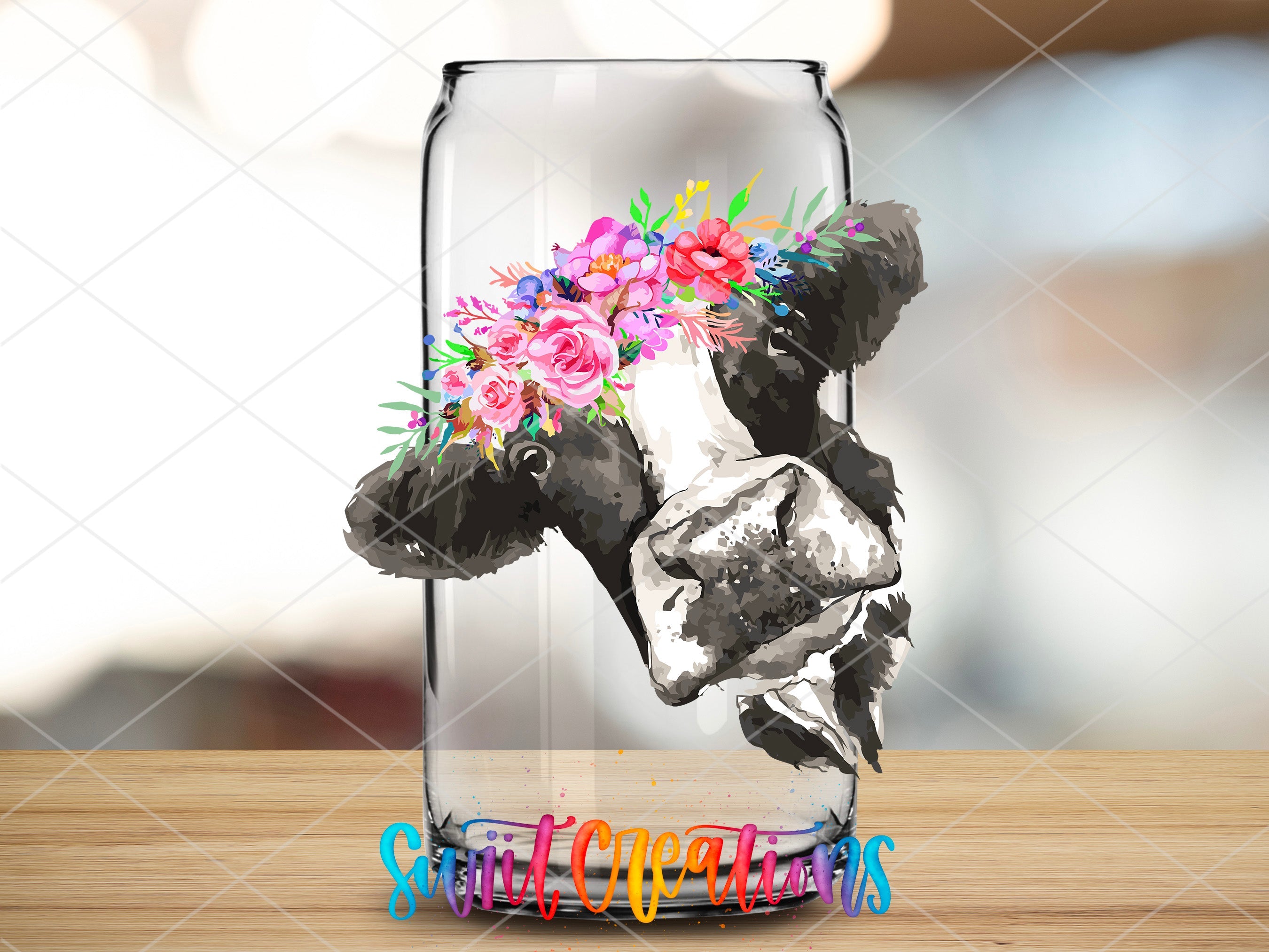 a glass vase with a cow and flowers in it