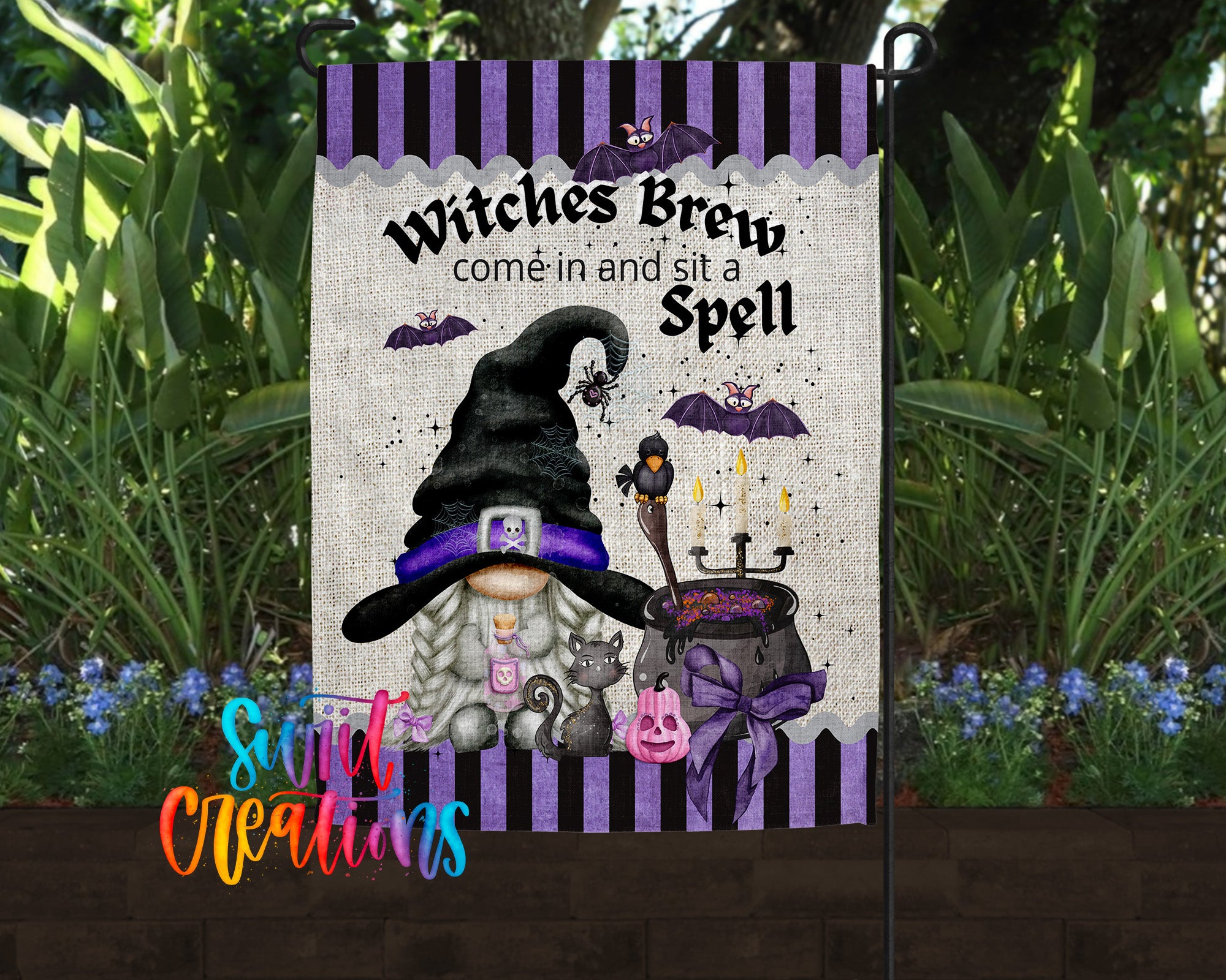 A garden sign featuring a witch's hat and a cauldron with bats and a broomstick, along with the text "Witches Brew come in and sit a Spell".