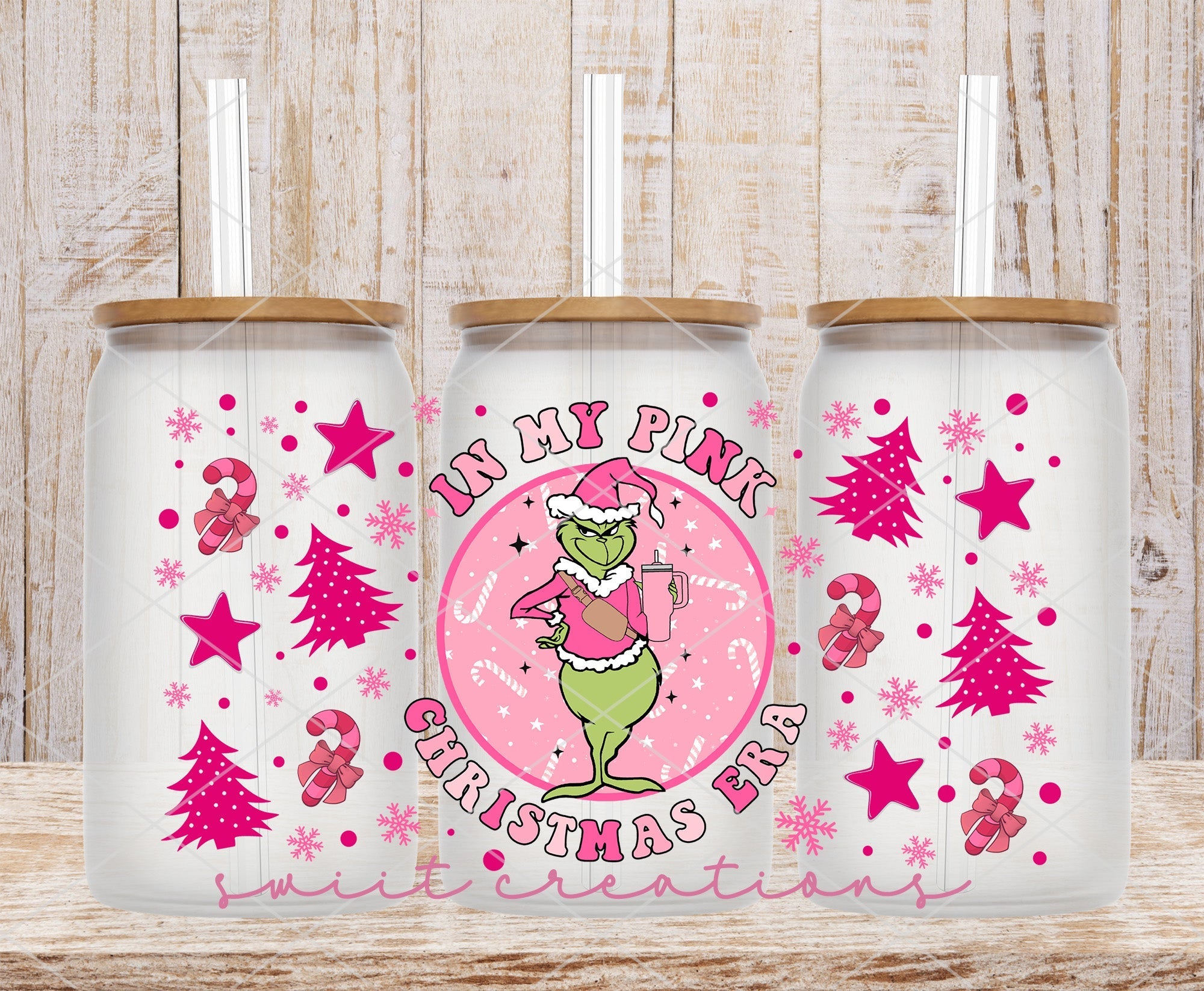a couple of pink christmas mugs sitting on top of a wooden table
