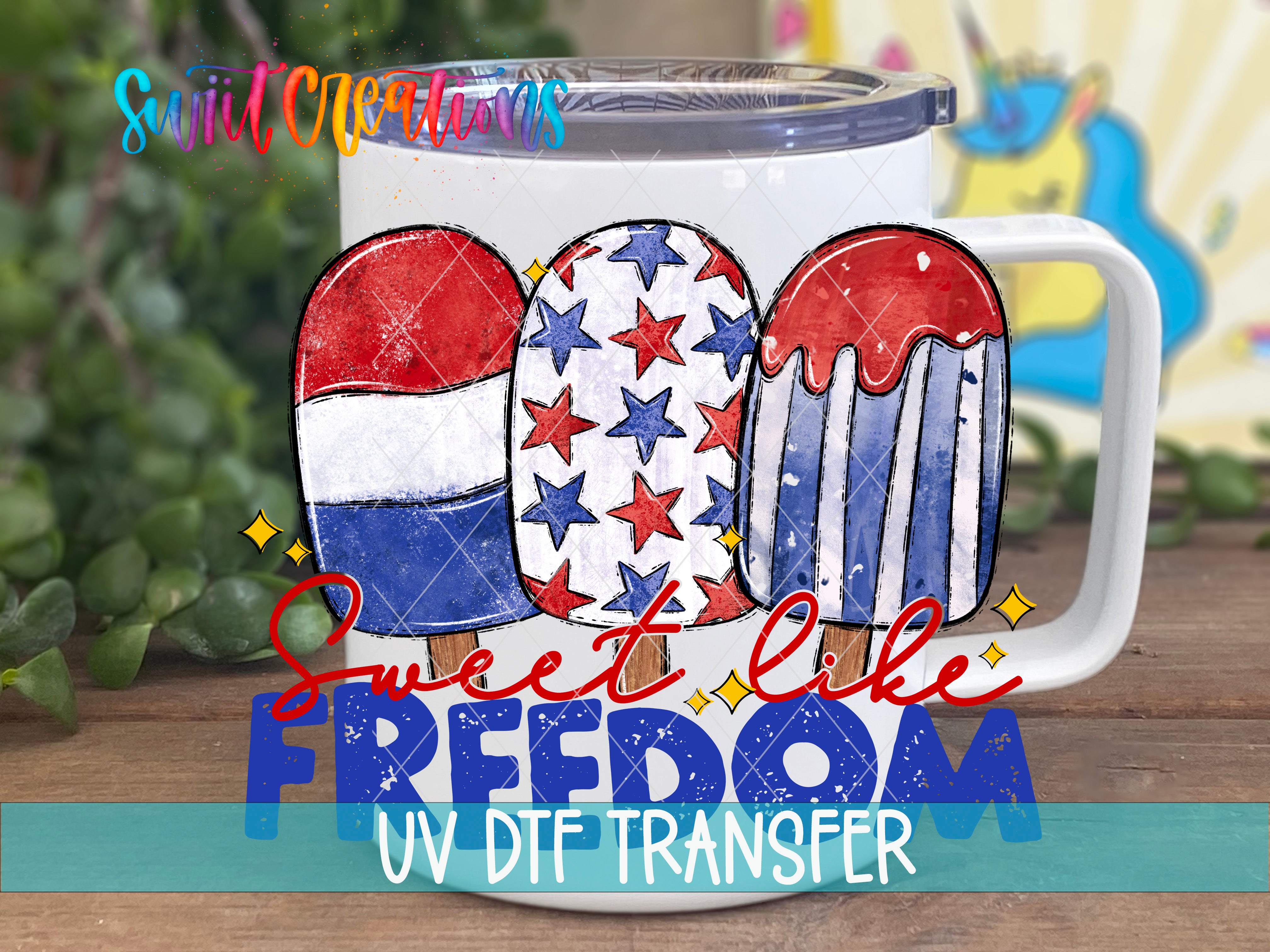 A white mug with a patriotic design featuring three popsicles in red, white, and blue colors, along with the text "Sweet like freedom" and "UV DFT Transfer".