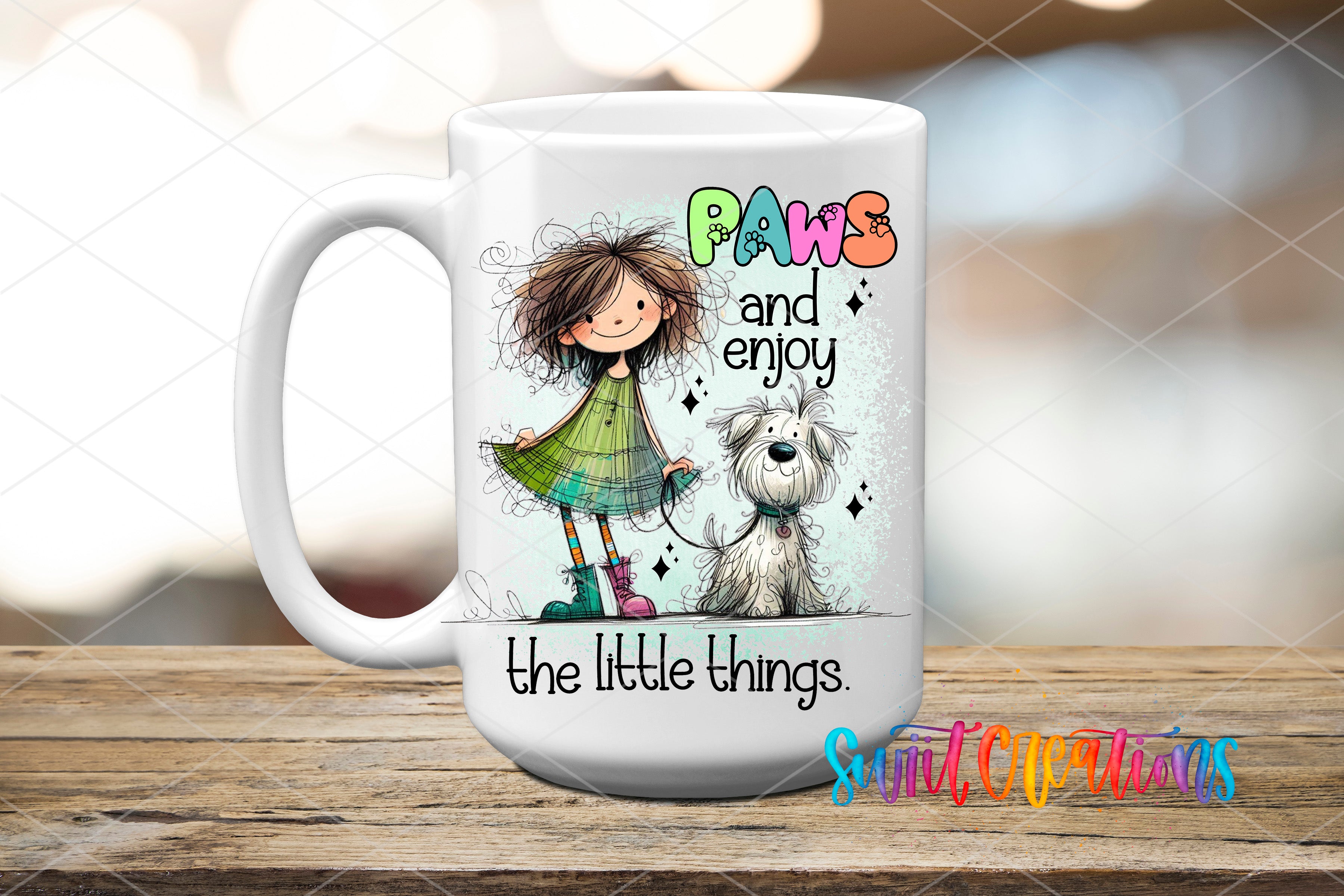 A white ceramic mug with a colorful illustration of a girl and a dog, along with the text "Paws and enjoy the little things" and "the little things" written on it.