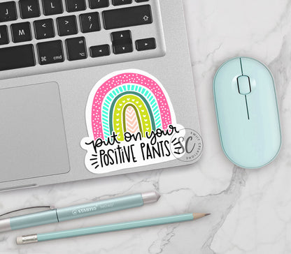 a laptop with a sticker on it next to a mouse