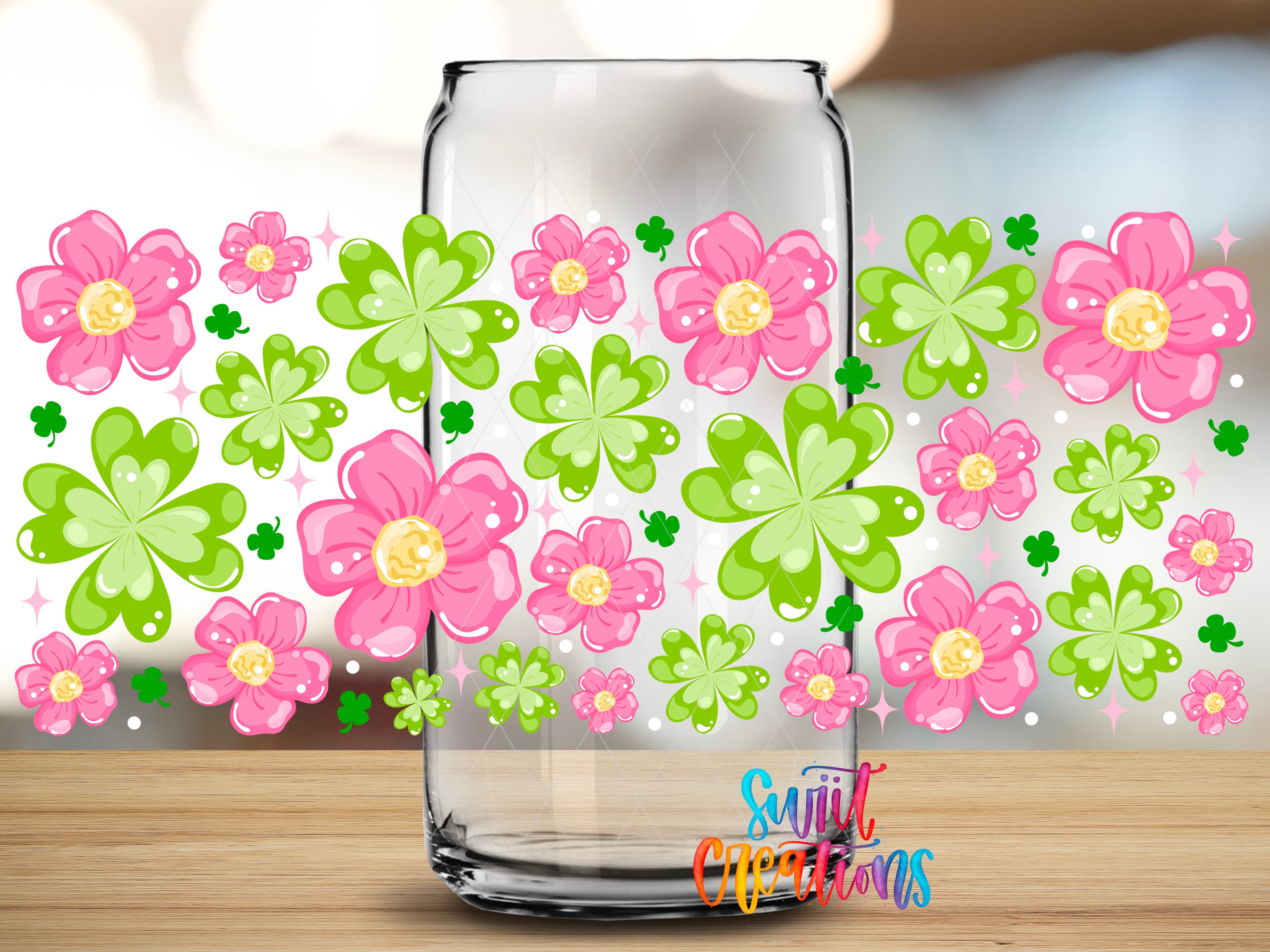 a clear glass jar filled with colorful flowers and clovers, placed on a wooden surface.