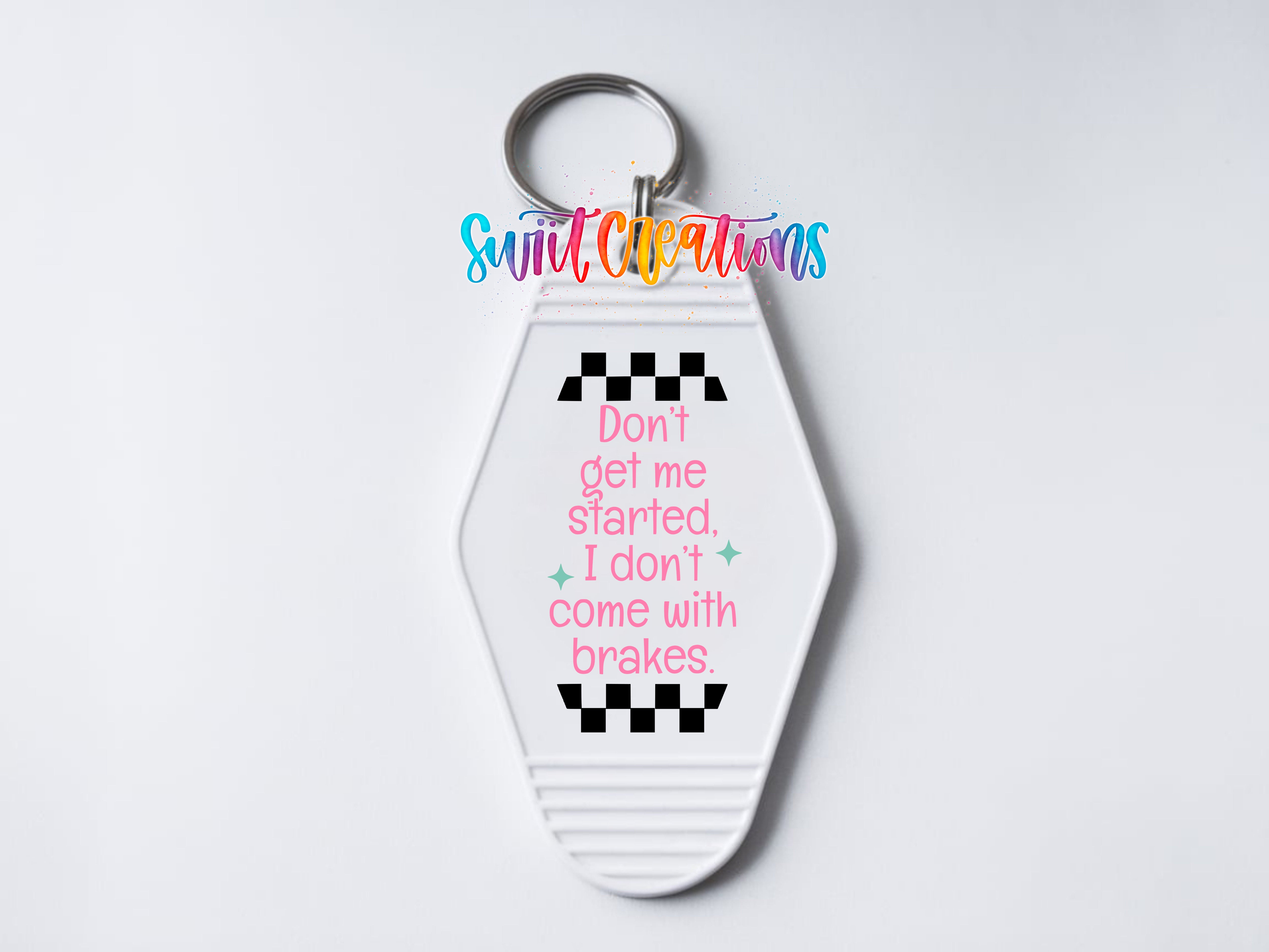 A keychain with a checkered pattern and text on it.