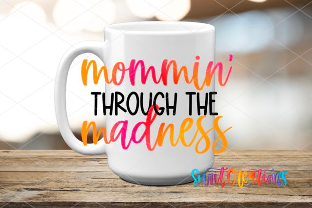 a coffee mug with the words mommy through the madness on it