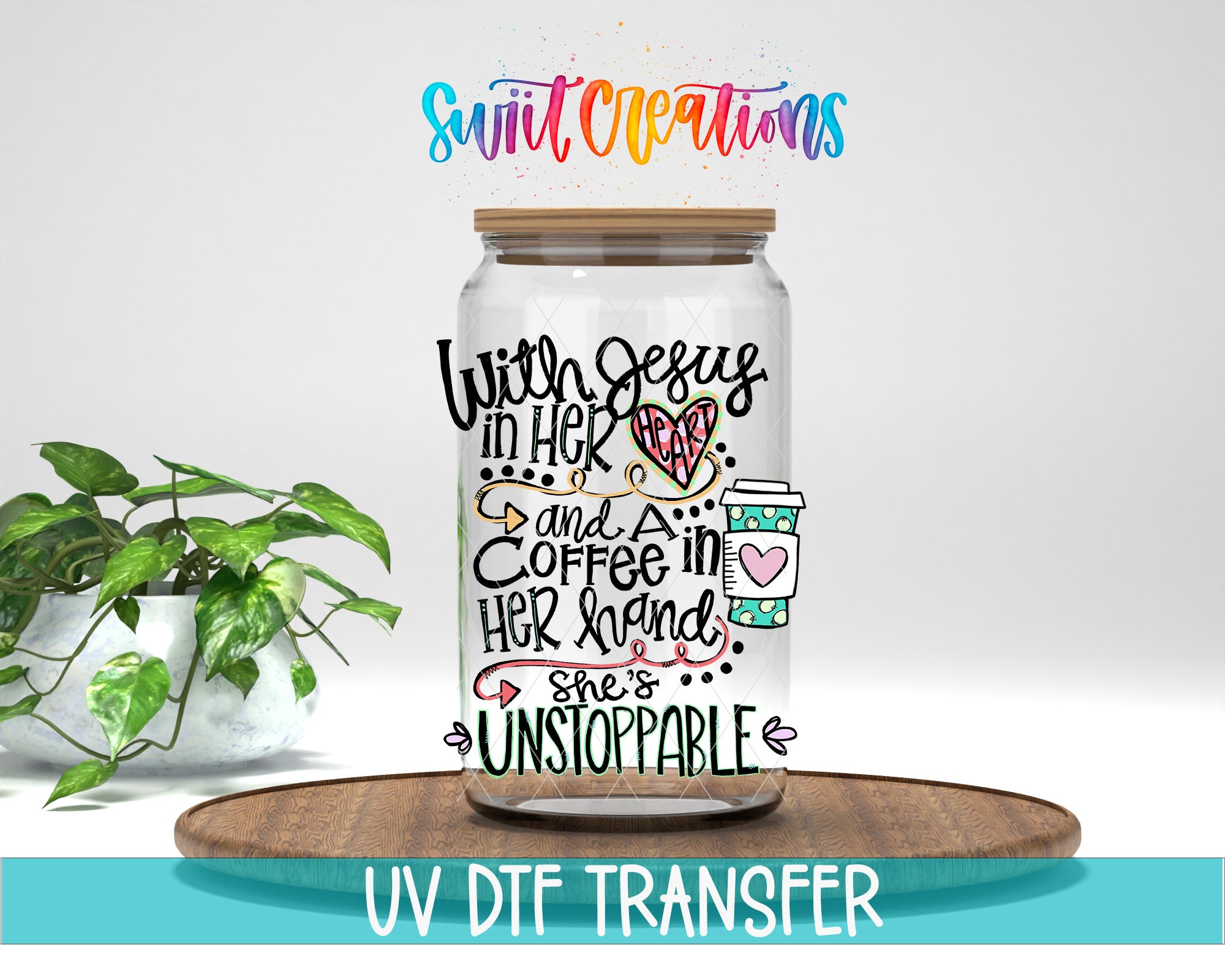 A glass jar with a colorful, hand-drawn design on it, placed on a wooden surface. The jar has a coffee cup and heart-shaped decorations. The background is white, and there is a plant to the left of the jar.