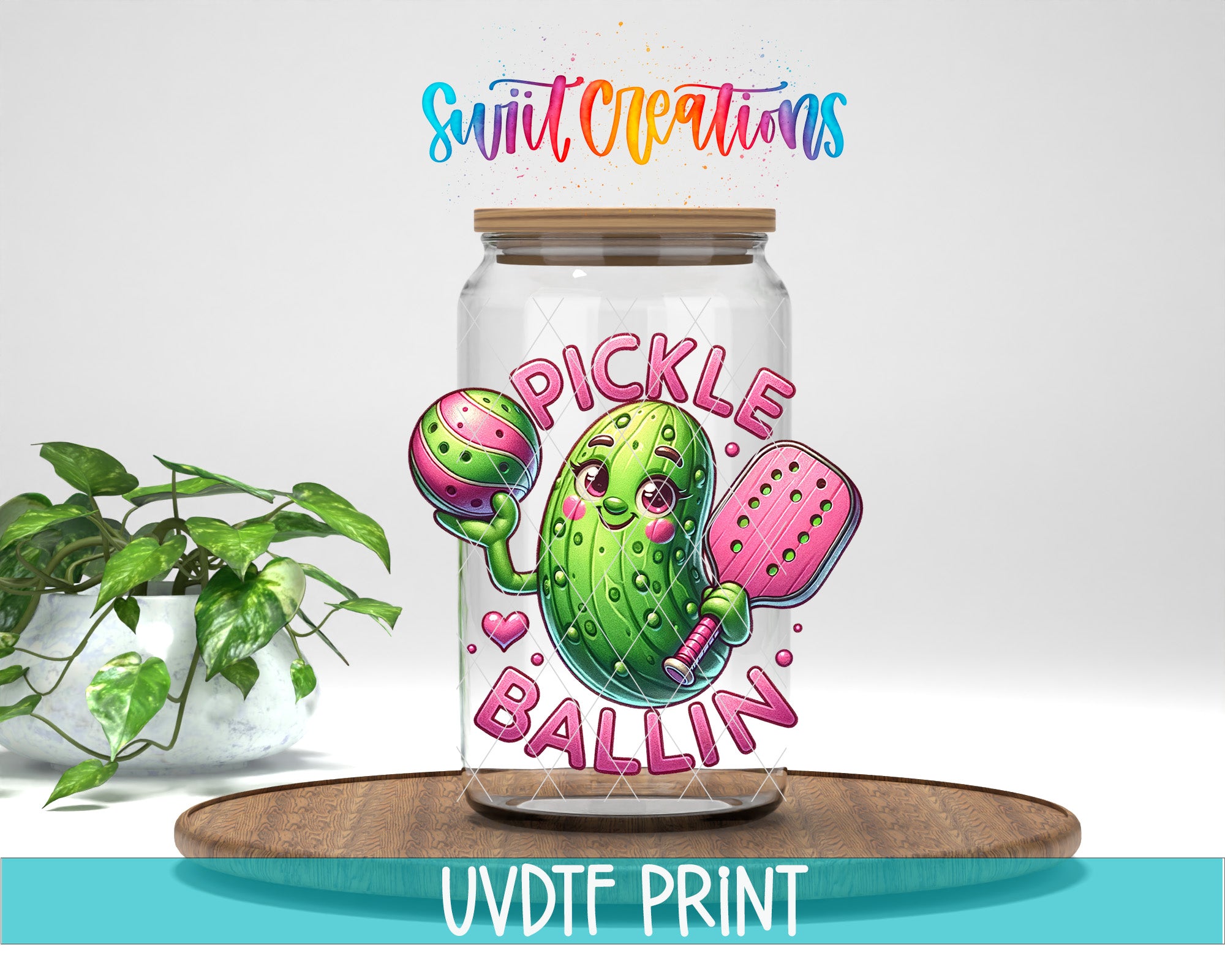 a glass jar with a cartoon pickle character holding a tennis ball and a paddle, along with the text "PICKLE BALLIN" and "Swift Creations" written above it.