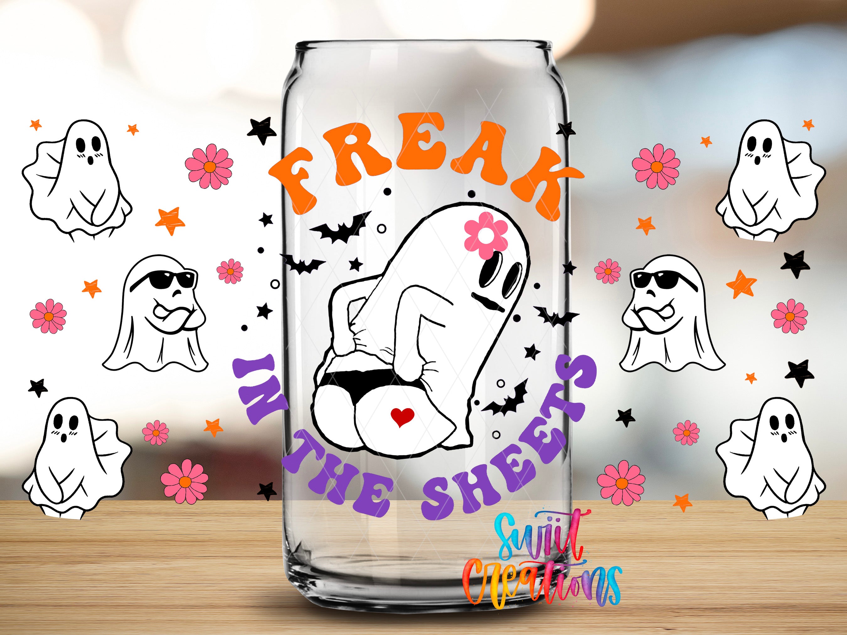 a glass can with a cartoon ghost and the text "Freak in the Sheets" printed on it, surrounded by various ghost-related graphics and flowers.