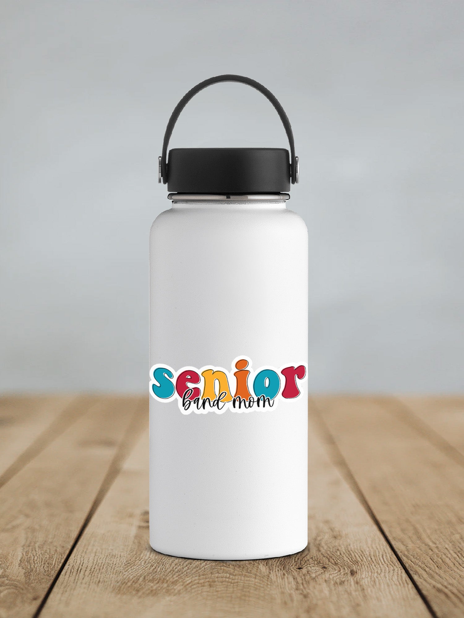 a white water bottle sitting on top of a wooden table