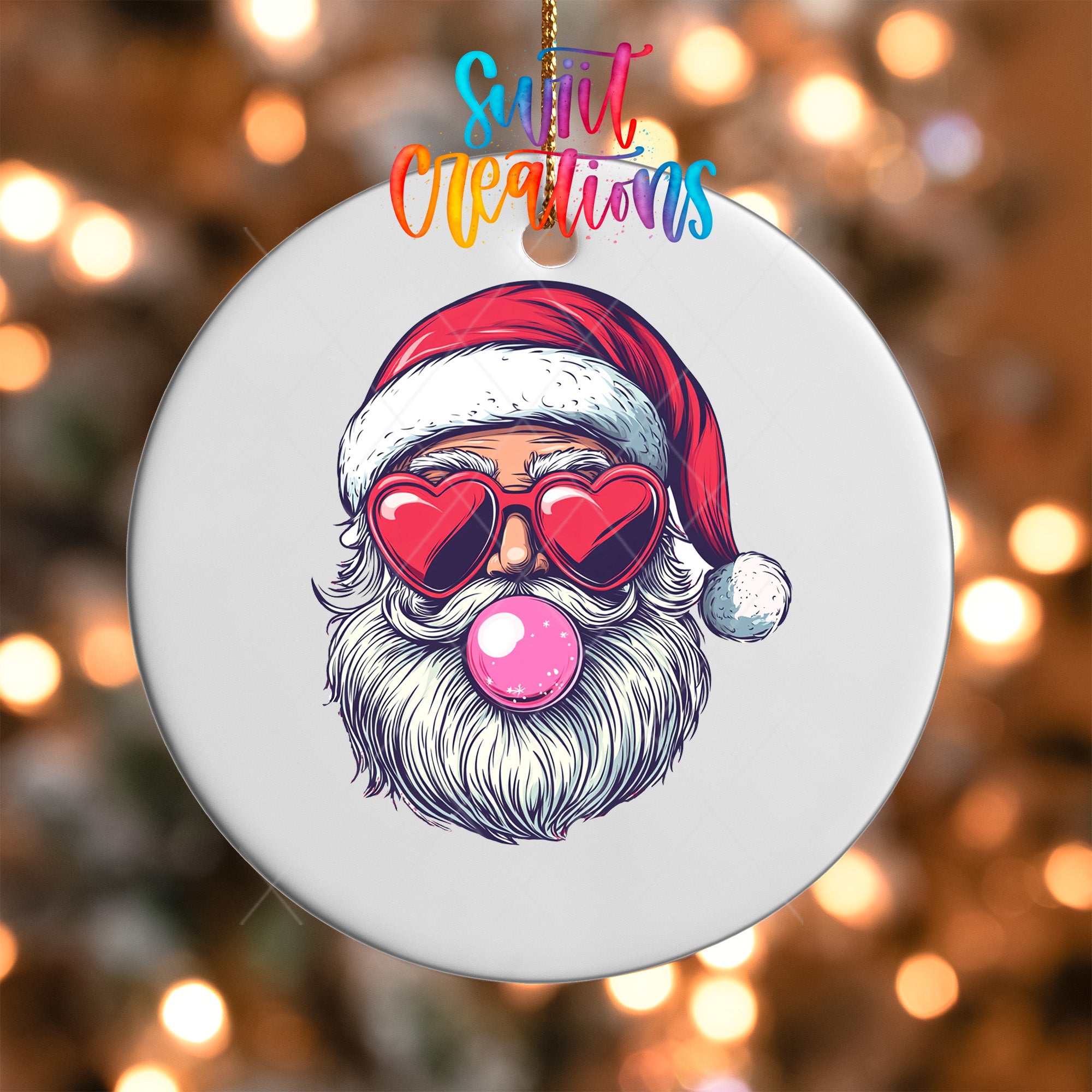 A white ornament with a Santa Claus face wearing sunglasses and a red hat, with a pink bubble gum bubble in his mouth.