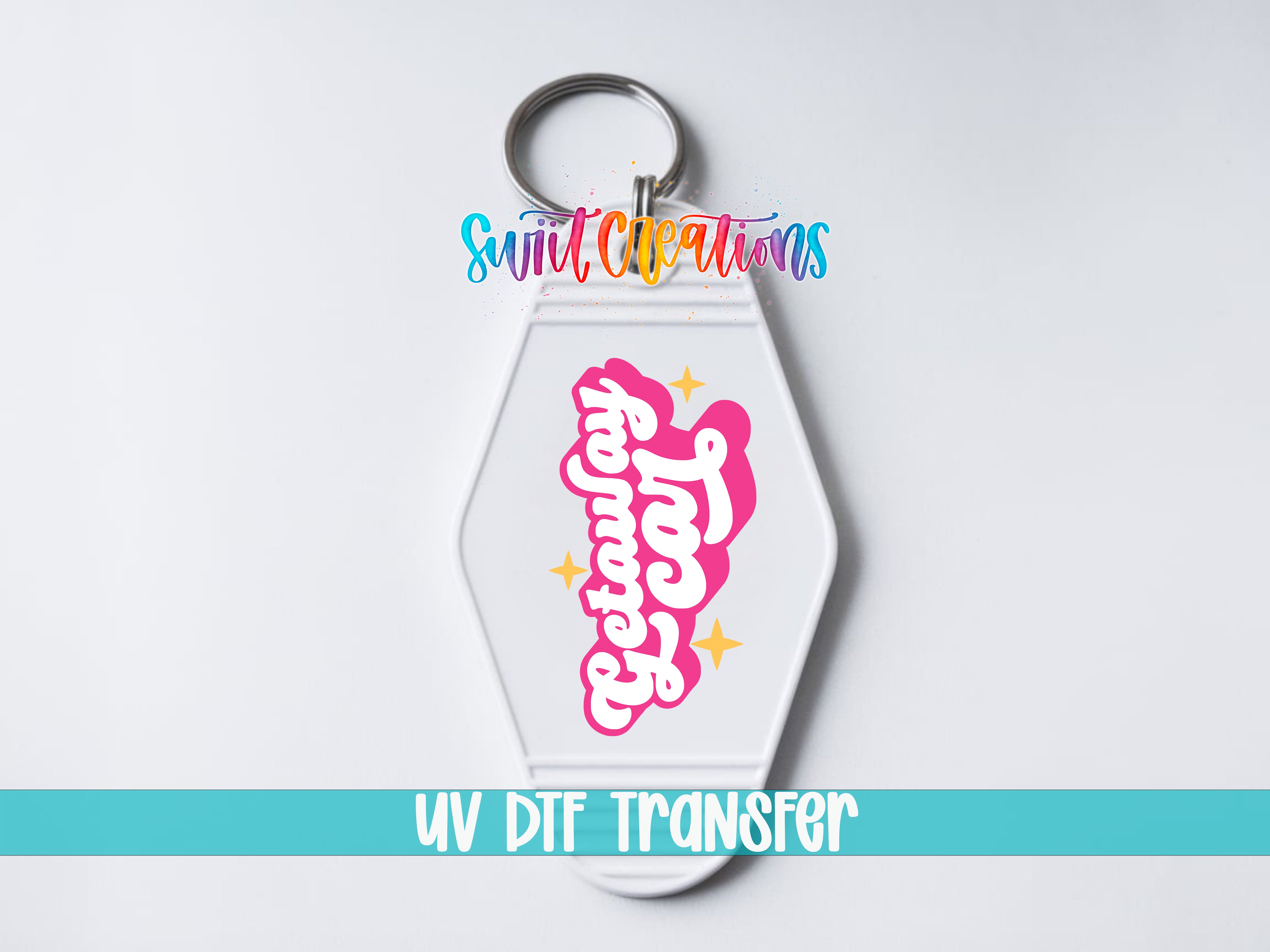 A keychain with a colorful design and text, including the words "Sunlit Creations" and "UV DDF Transfer".