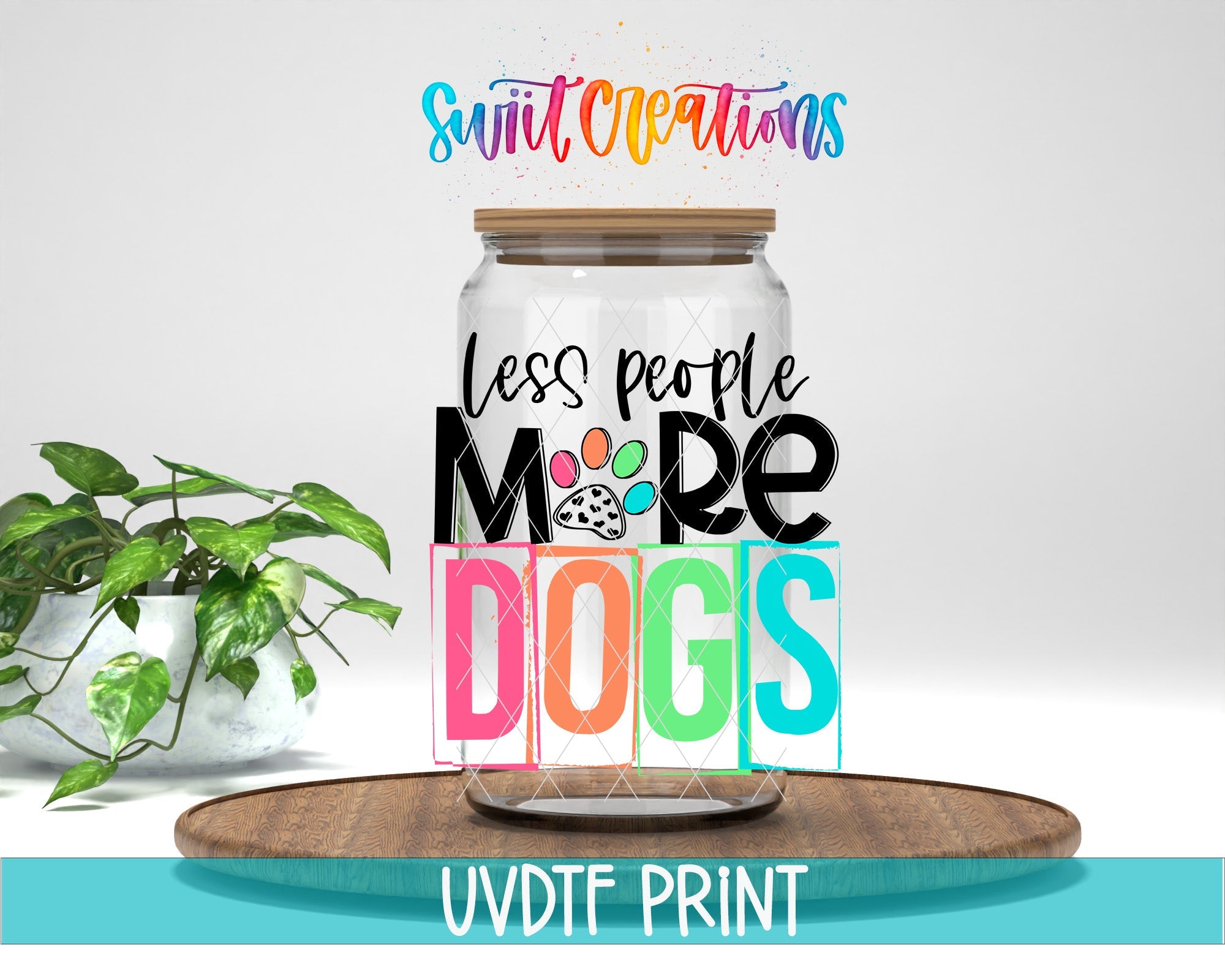 a glass jar filled with colorful letters and a plant