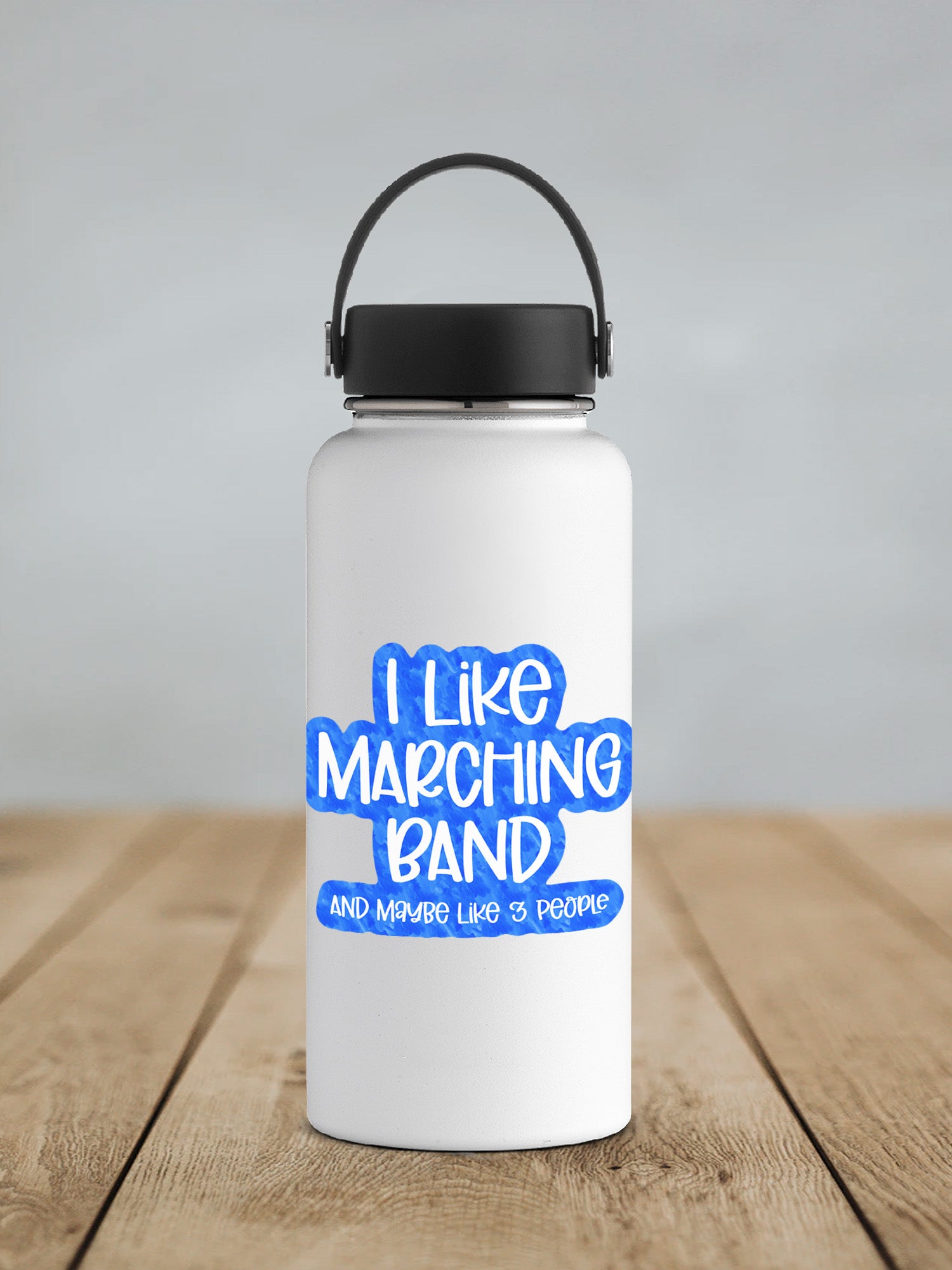 a white water bottle sitting on top of a wooden table
