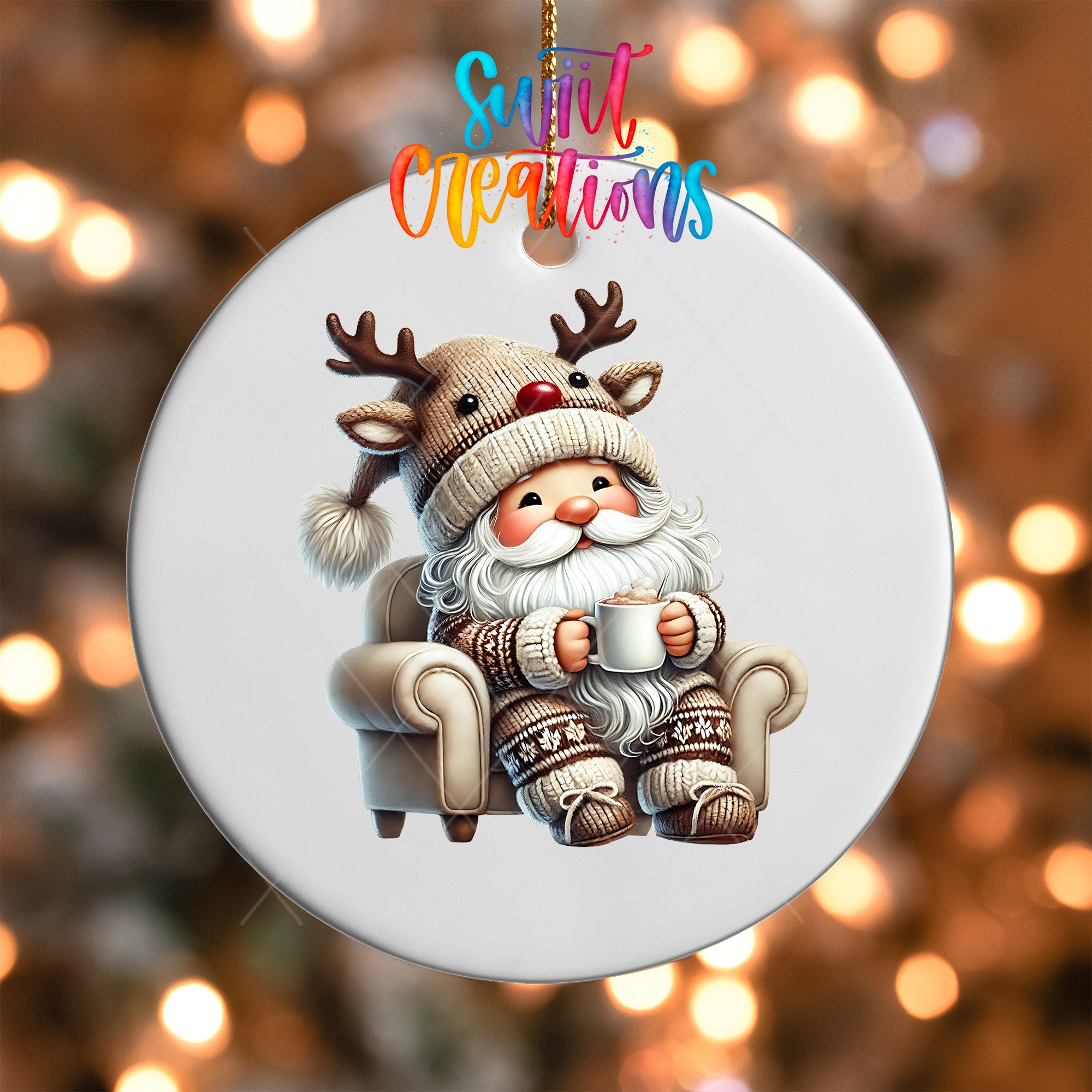 A white ornament featuring a cartoon Santa Claus sitting in a chair, wearing a reindeer hat and holding a cup of coffee.