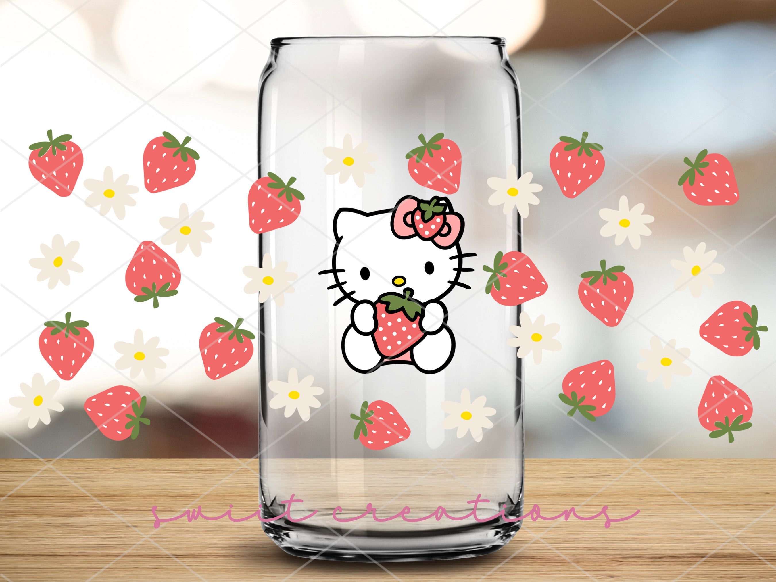 a glass with a picture of a hello kitty holding a strawberry