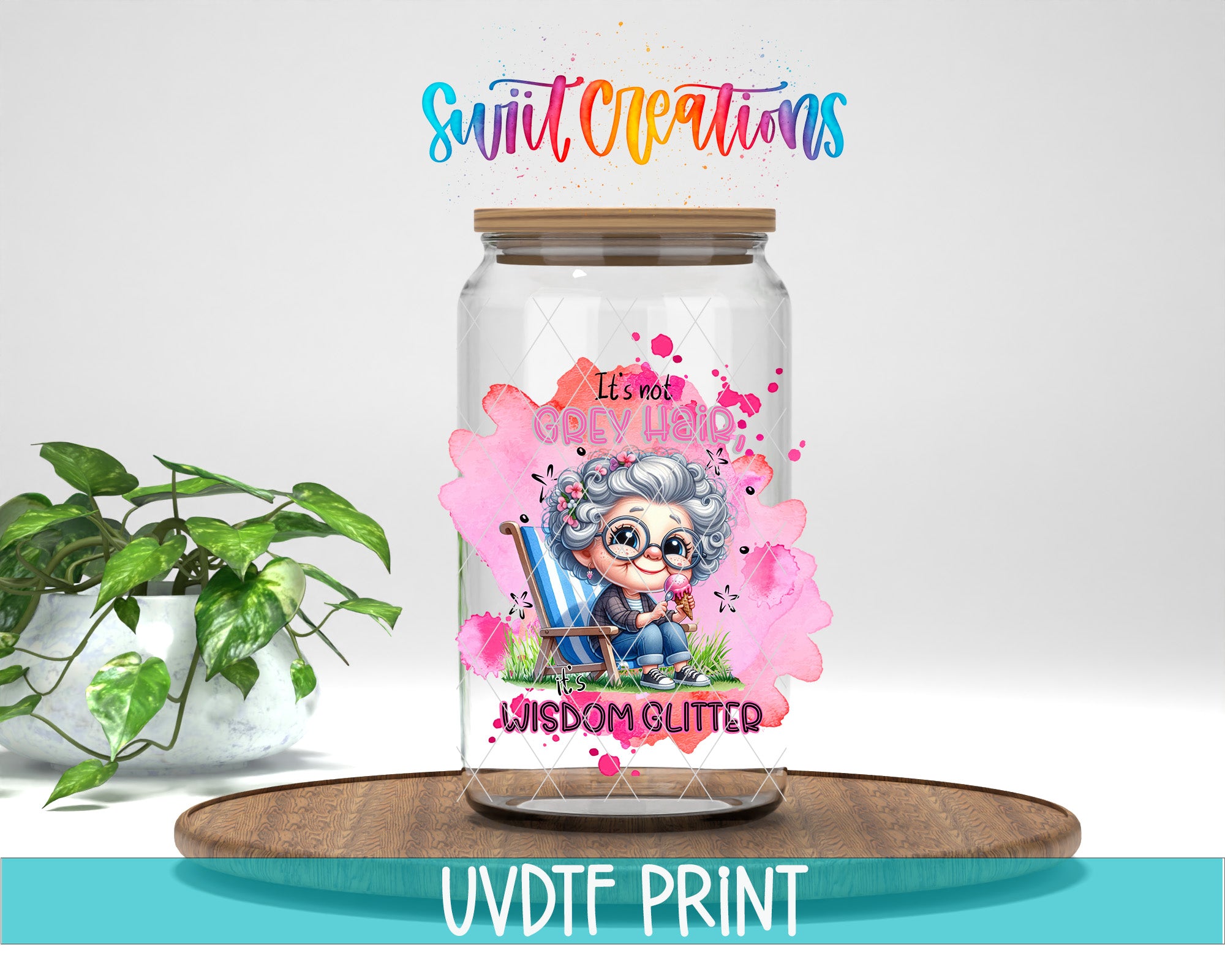 a glass jar with a colorful illustration of a cartoon character, along with the text "It's not just glitter Wisdom glitter" printed on it. The jar is placed on a wooden surface, and there is a potted plant in the background.