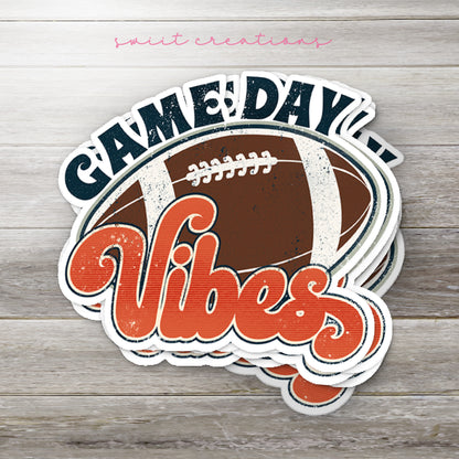 Stack of Football Game Day Vibes glossy stickers on a gray wood table