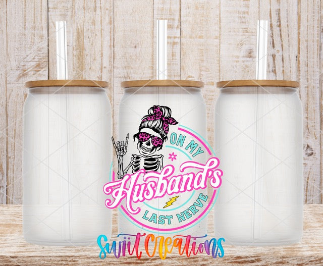 a couple of white jars sitting on top of a wooden table