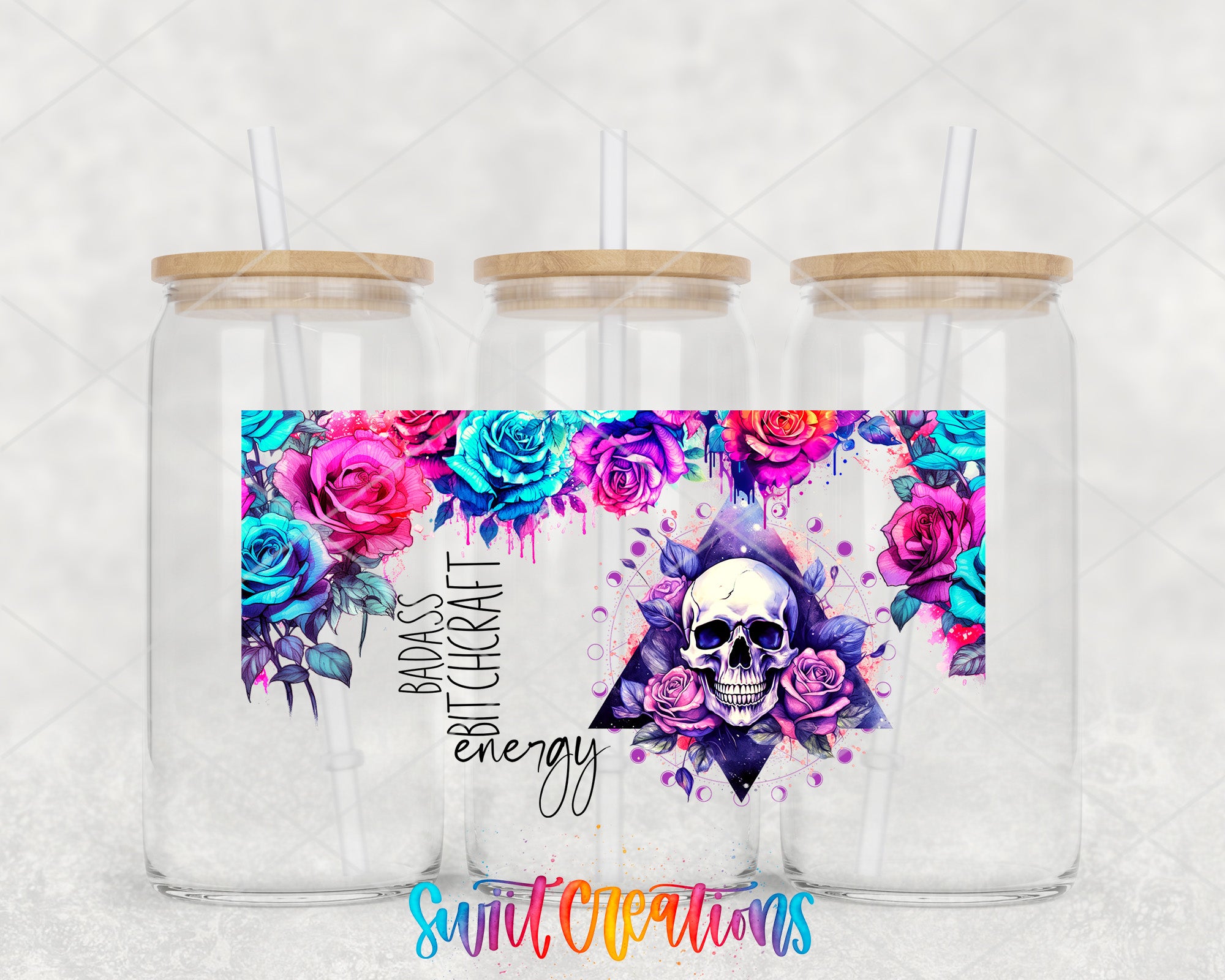 A colorful glass jar with a wooden lid, featuring a skull design surrounded by flowers in shades of pink, blue, and purple.
