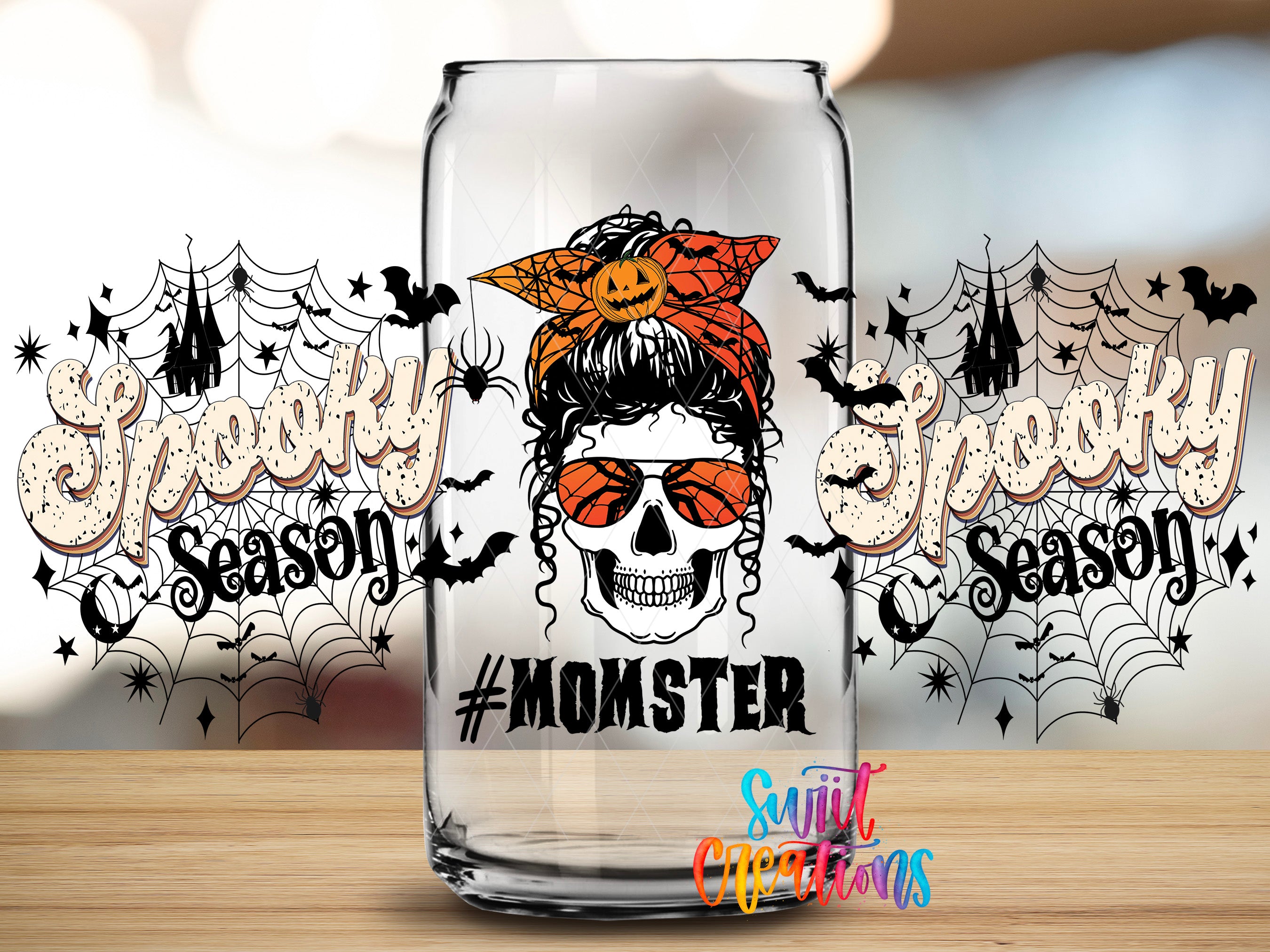 A glass can with a skull wearing a bandana and sunglasses, along with the text "#MOMSTER" and the phrase "Spooky Season" written on it.