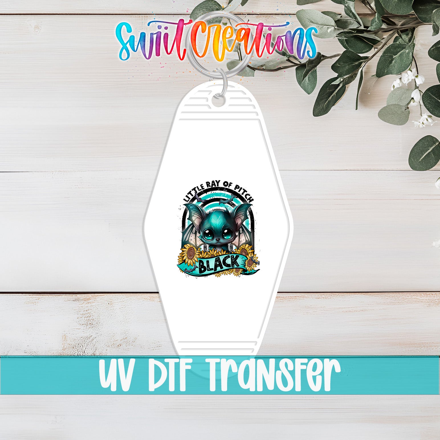 A keychain with a colorful design featuring a cat and the text "Little Ray of Pitch" and "Black".