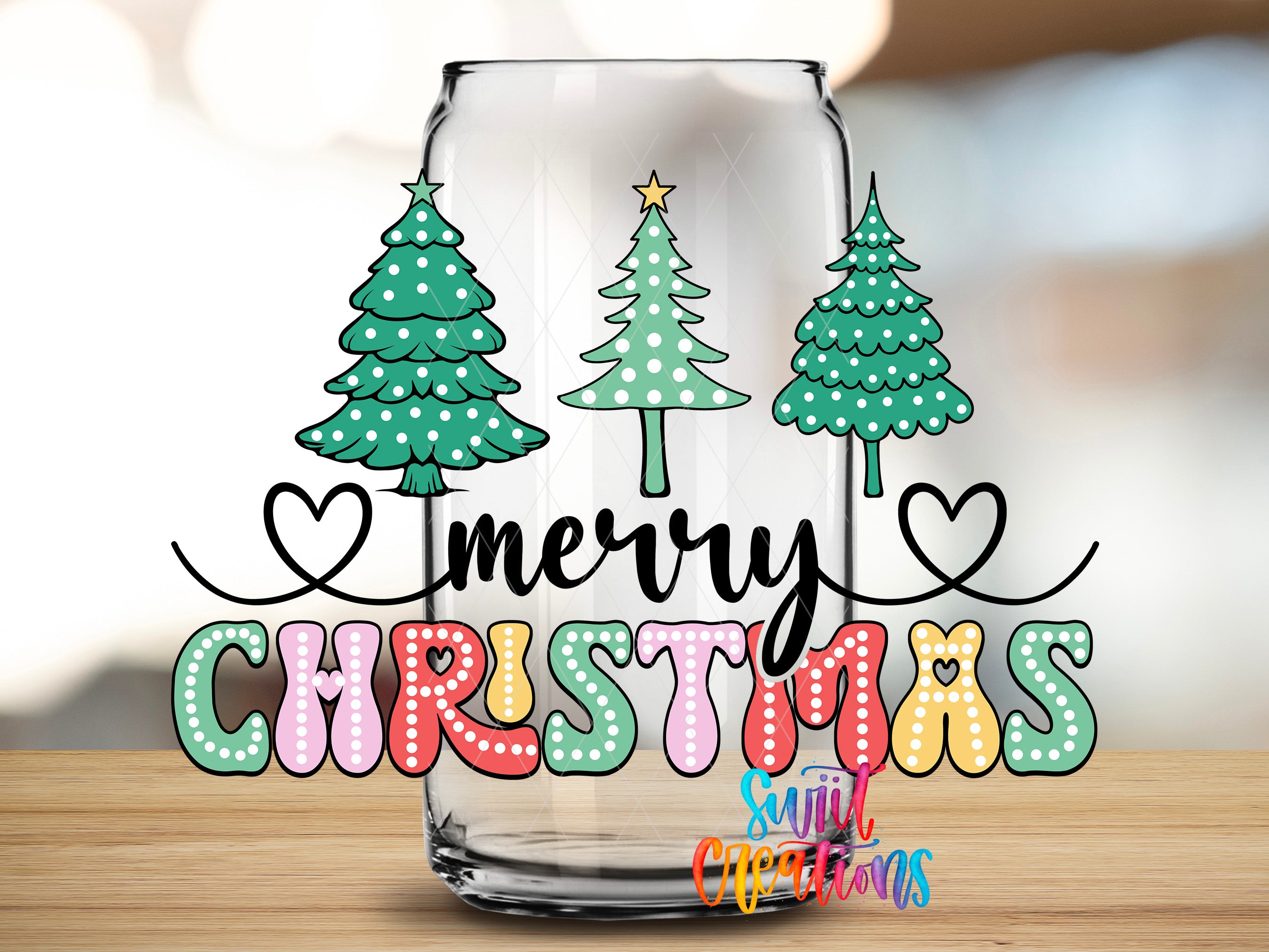 A glass jar with a festive Christmas tree design and the text "Merry Christmas" written on it.