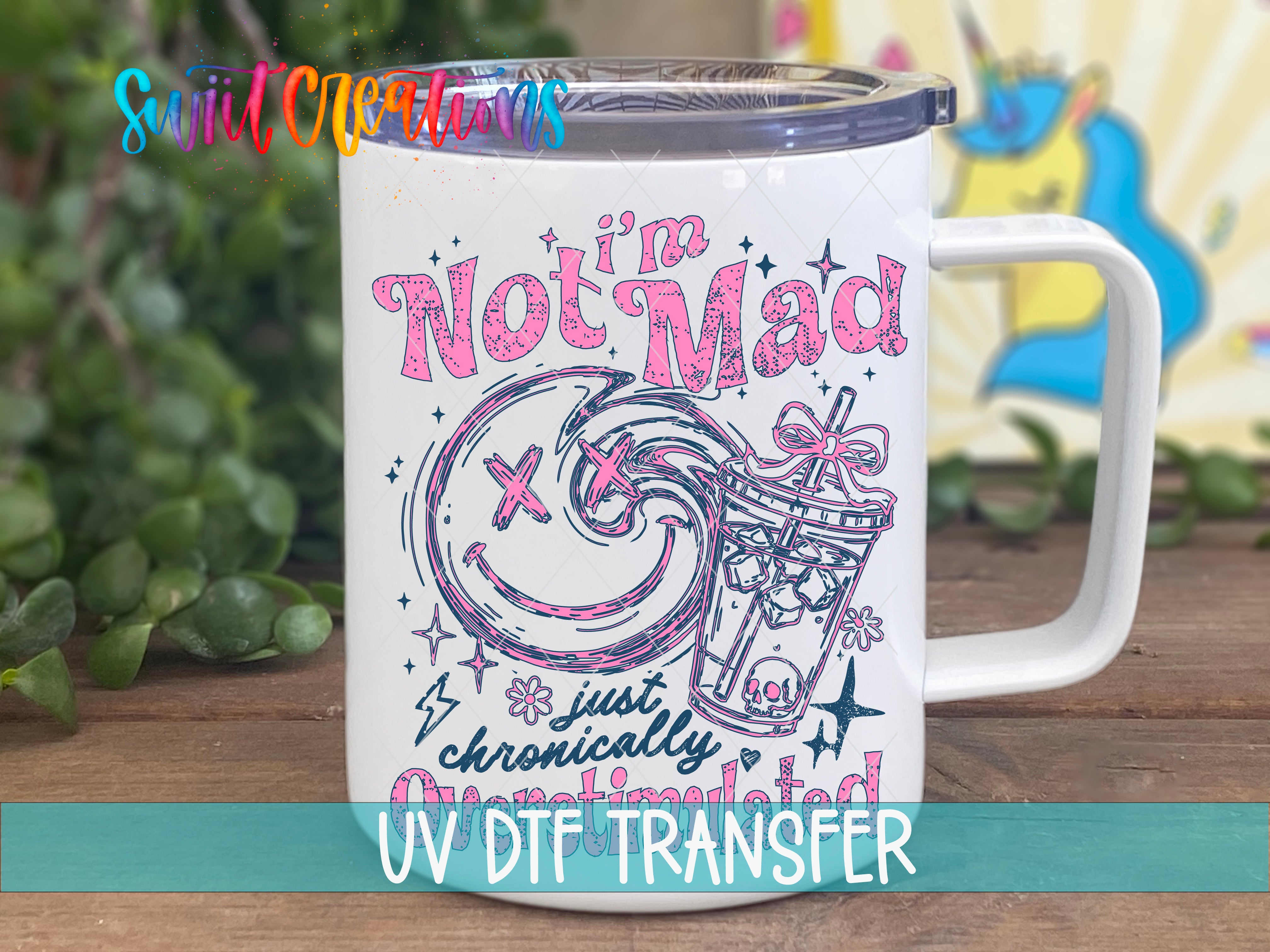 A white mug with a colorful design and text printed on it, placed on a wooden surface.