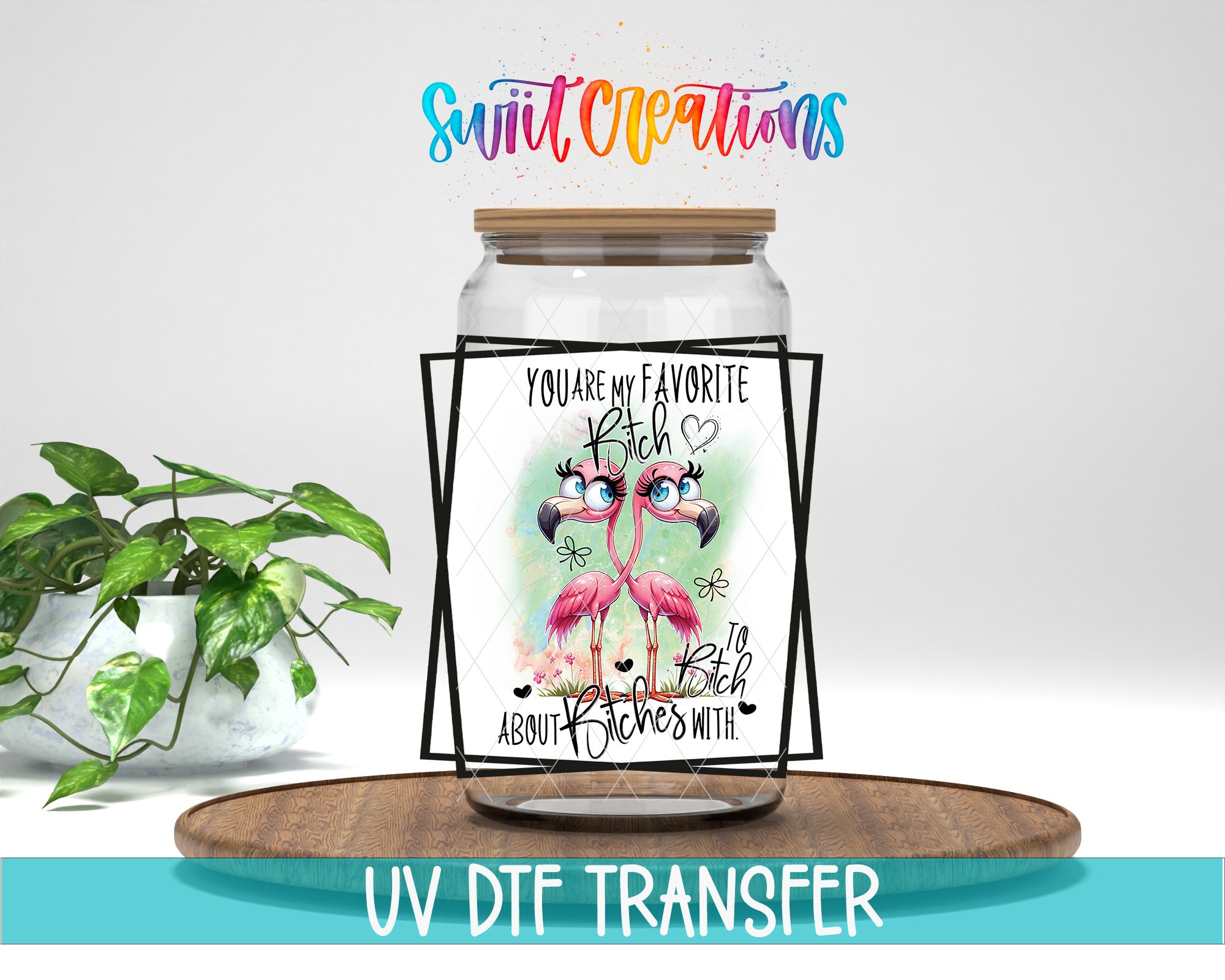 A glass jar with a label featuring a flamingo and text, placed on a wooden surface next to a potted plant.