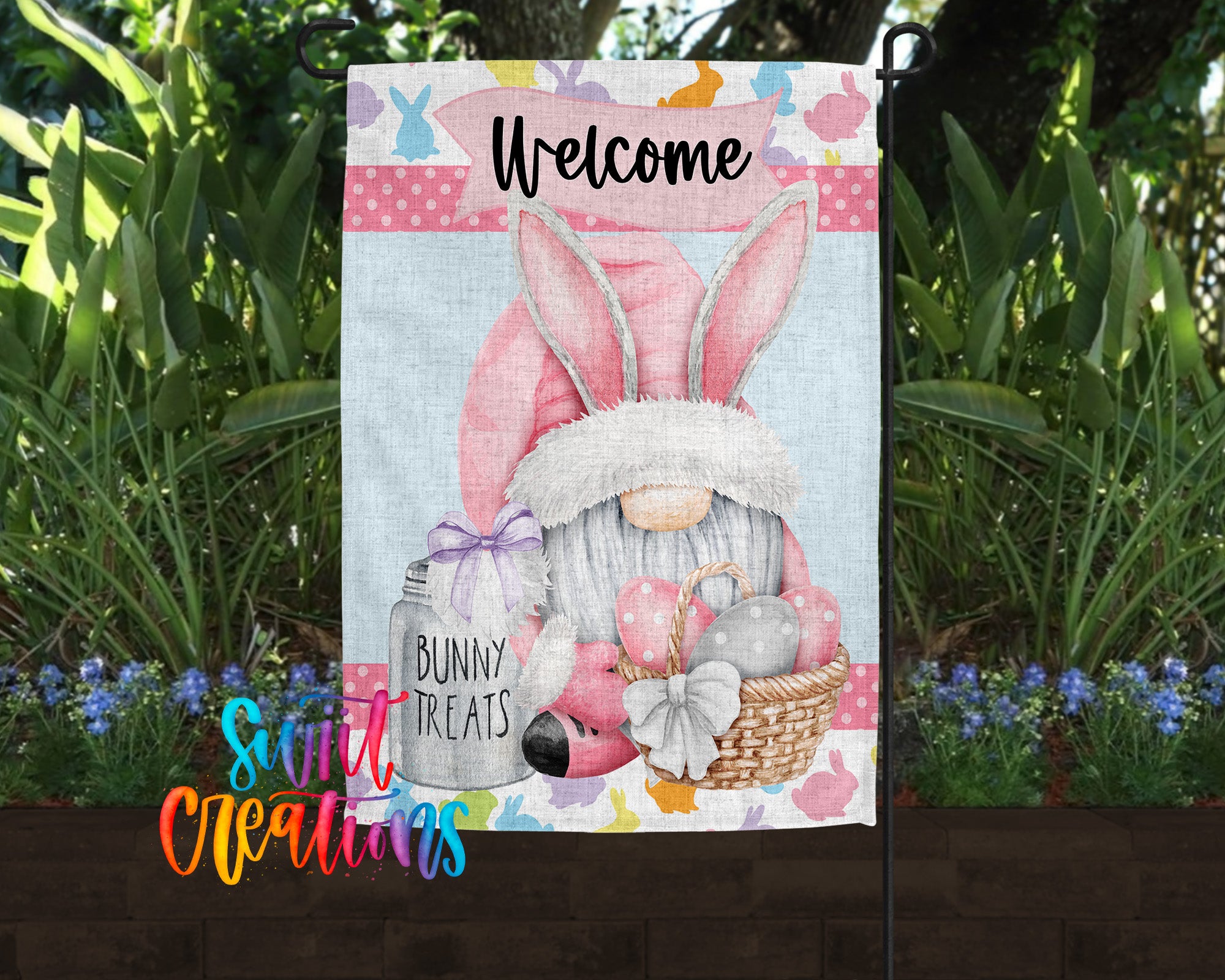 A colorful garden sign featuring a cartoon bunny gnome holding a basket of Easter eggs and treats, surrounded by flowers and greenery.