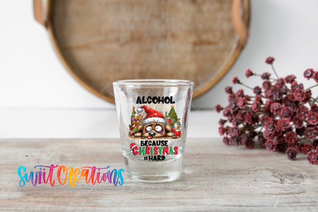 a shot glass sitting on a table next to a plant