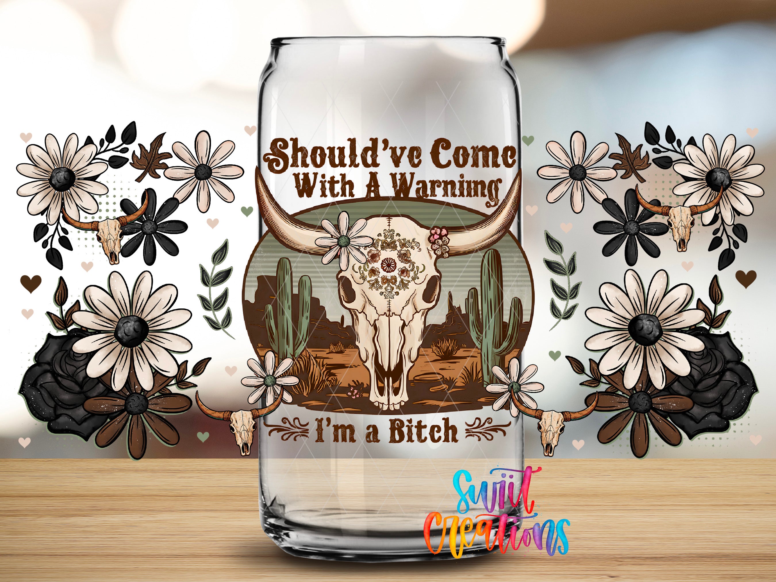 a glass can with a decorative design, including a skull, flowers, and cacti, along with the text "SHOULD'VE COME WITH A WARNING I'M A BITCH".