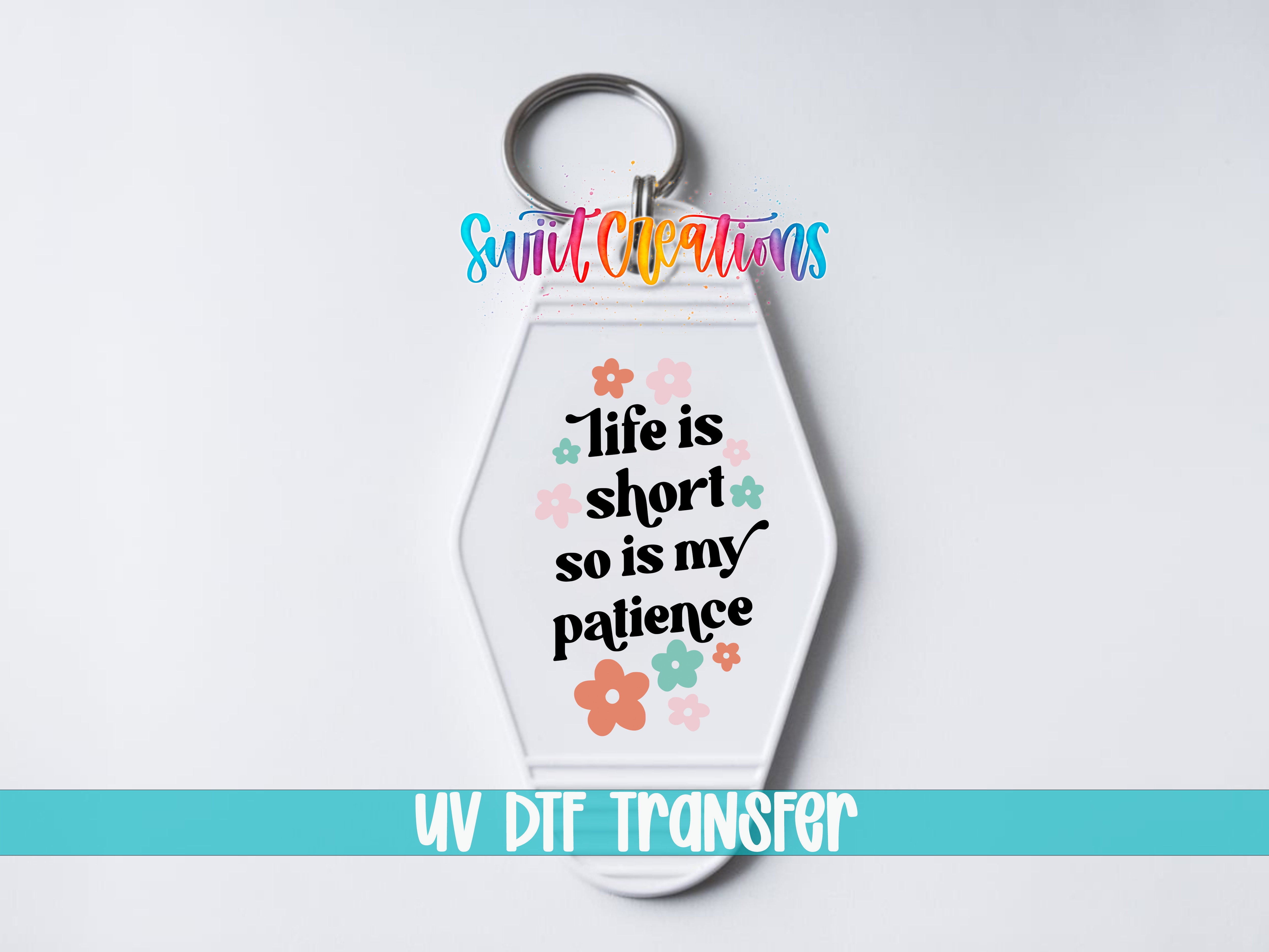 A keychain with a message that says "Life is short so is my patience" and colorful flowers surrounding it.
