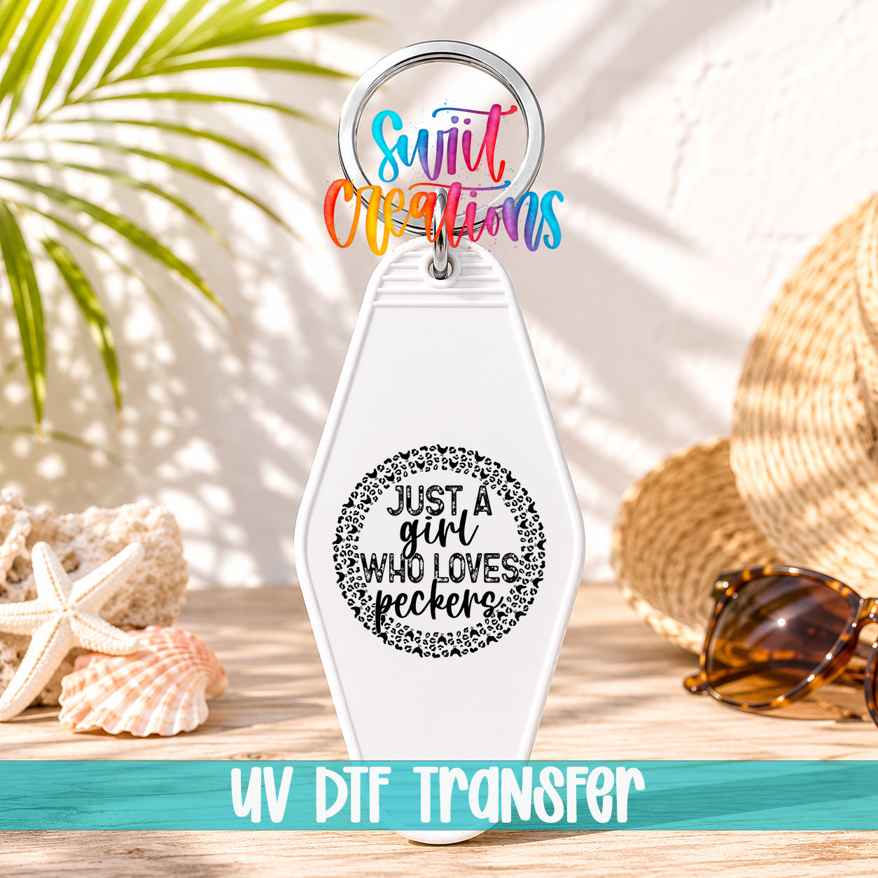 A keychain with a message that says "Just a girl who loves peckers" and a UVDF (UV dye transfer) logo, along with sunglasses and a straw hat on a beach background.