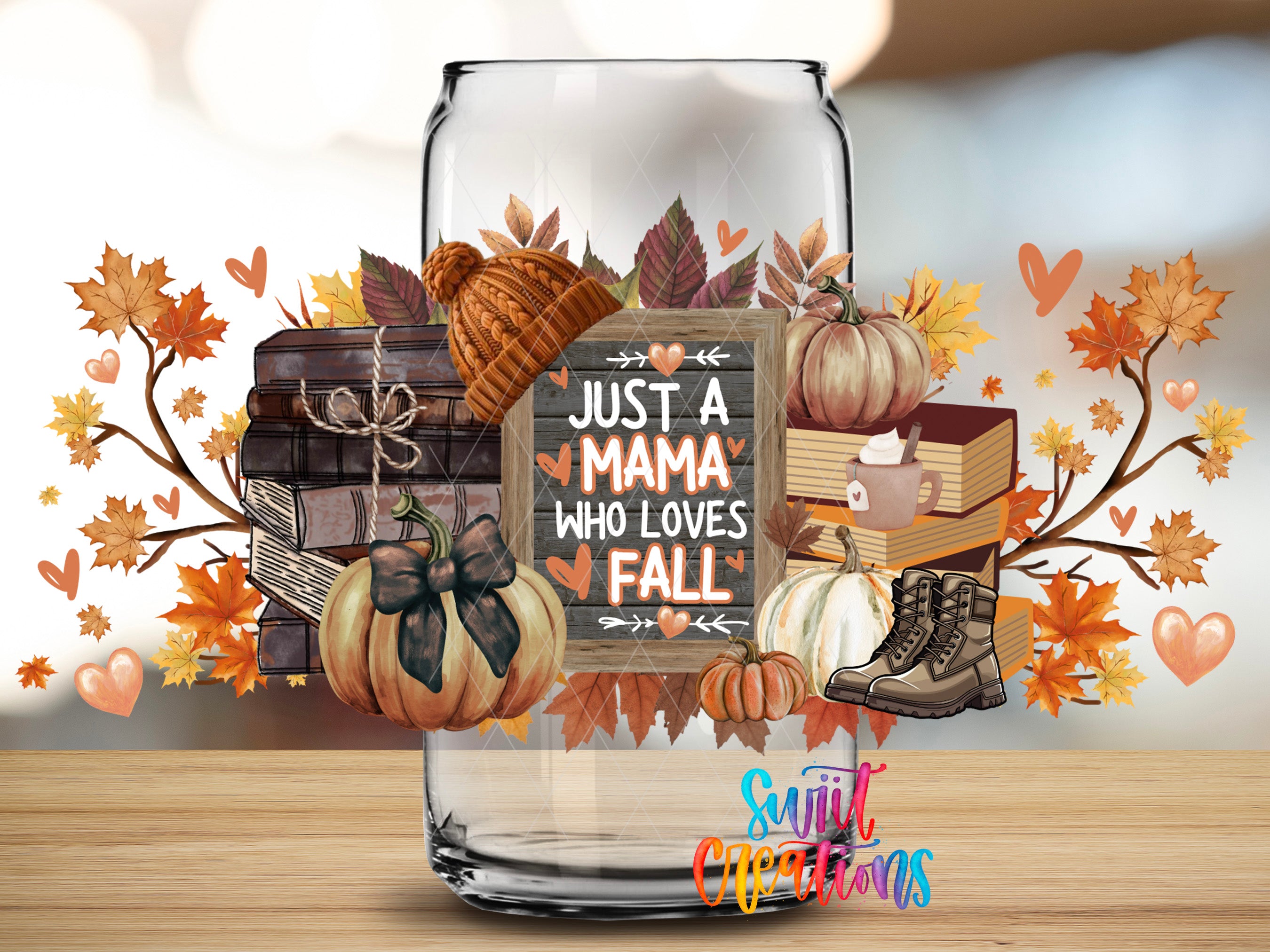 a glass jar filled with autumn-themed items, including pumpkins, books, and a sign that reads "Just a Mama who loves fall".