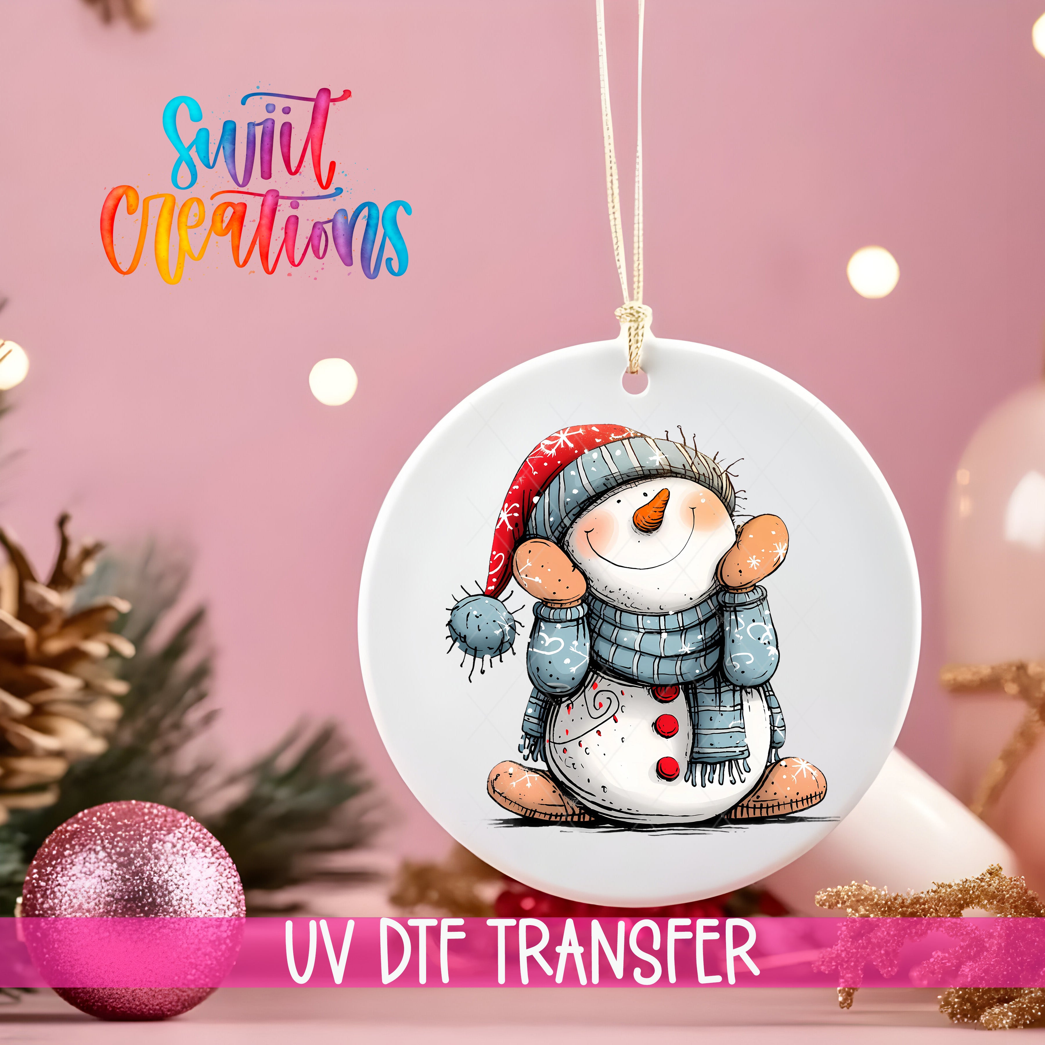 A white ceramic ornament with a snowman design hangs against a pink background, with a pink glitter ball and pine branches in the foreground.