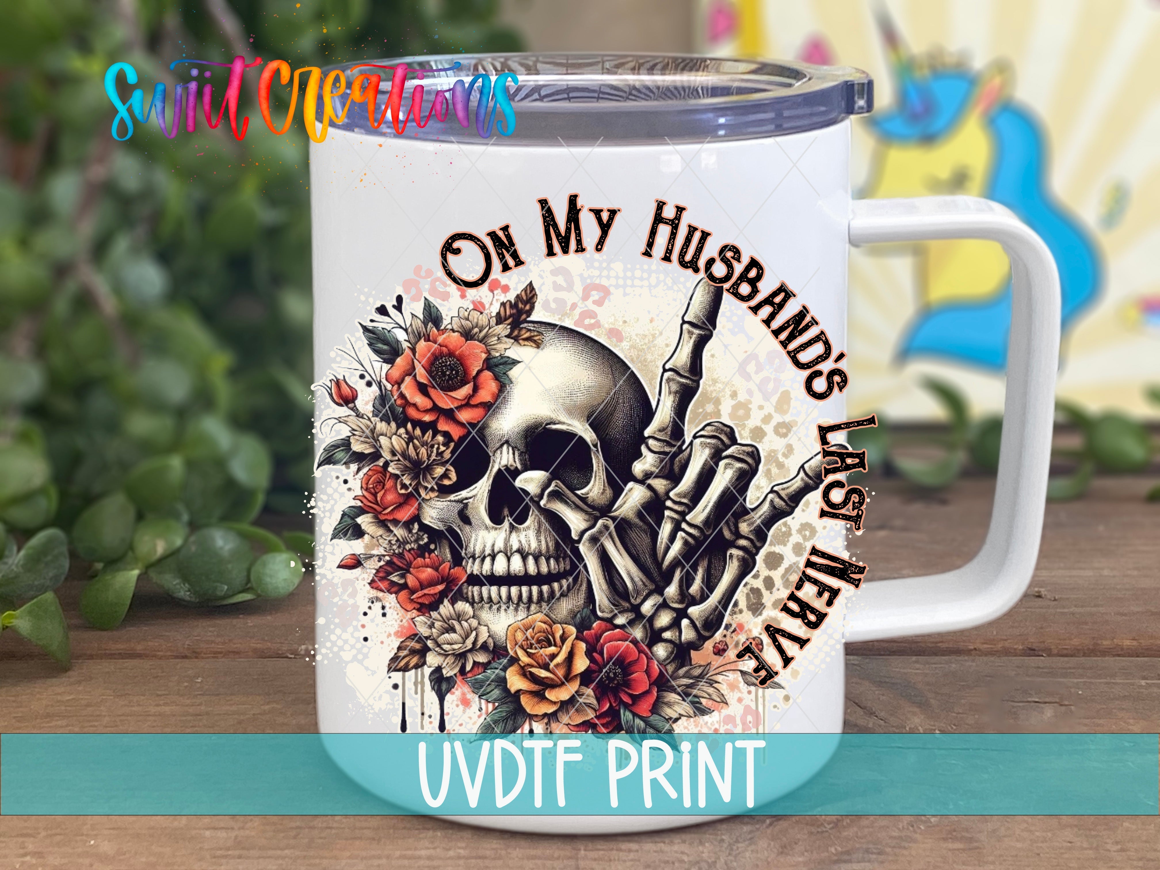 a white coffee mug with a skull and roses on it