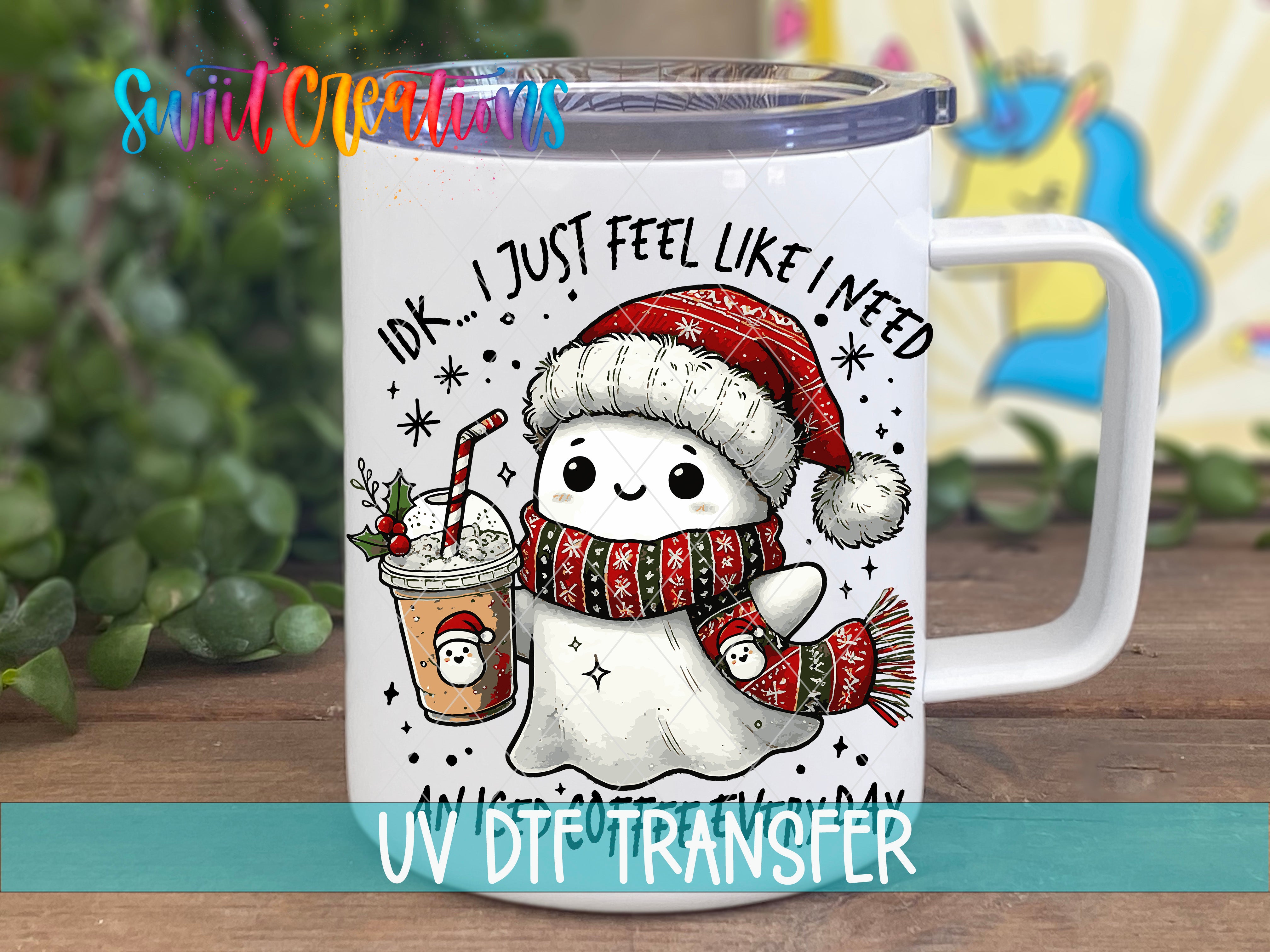 A mug with a cartoon ghost wearing a Santa hat and scarf, holding a drink, and surrounded by snowflakes and stars.