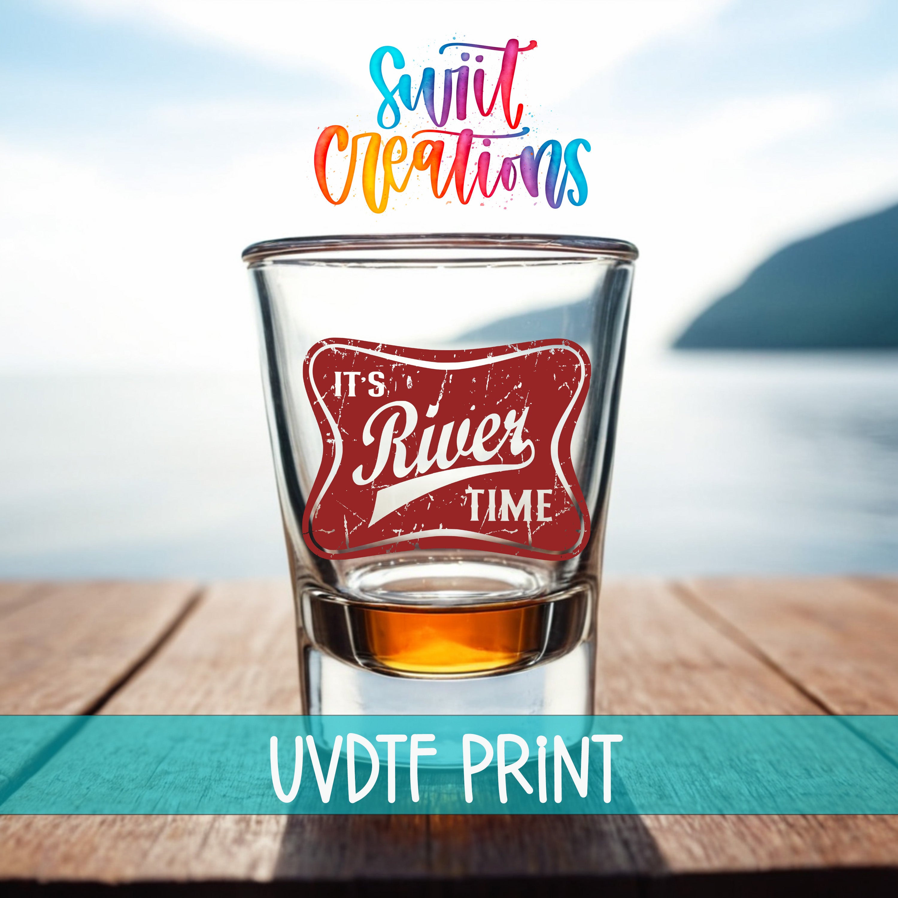 A glass with a red and white label that says "It's River Time" is placed on a wooden table, with a scenic view of a body of water in the background.