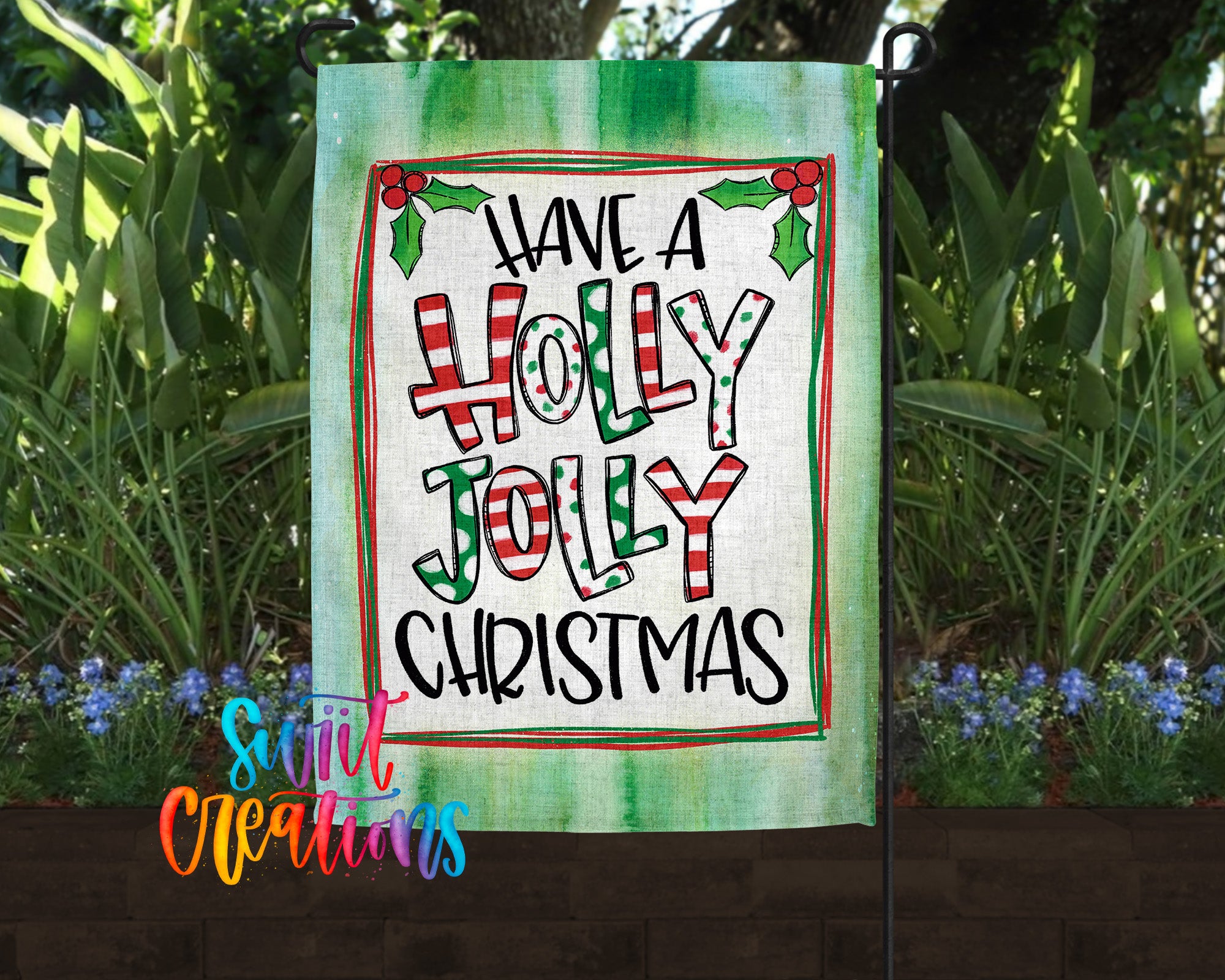 A garden flag with a festive holiday message, featuring the text "Have a Holly Jolly Christmas" in a colorful, decorative font.