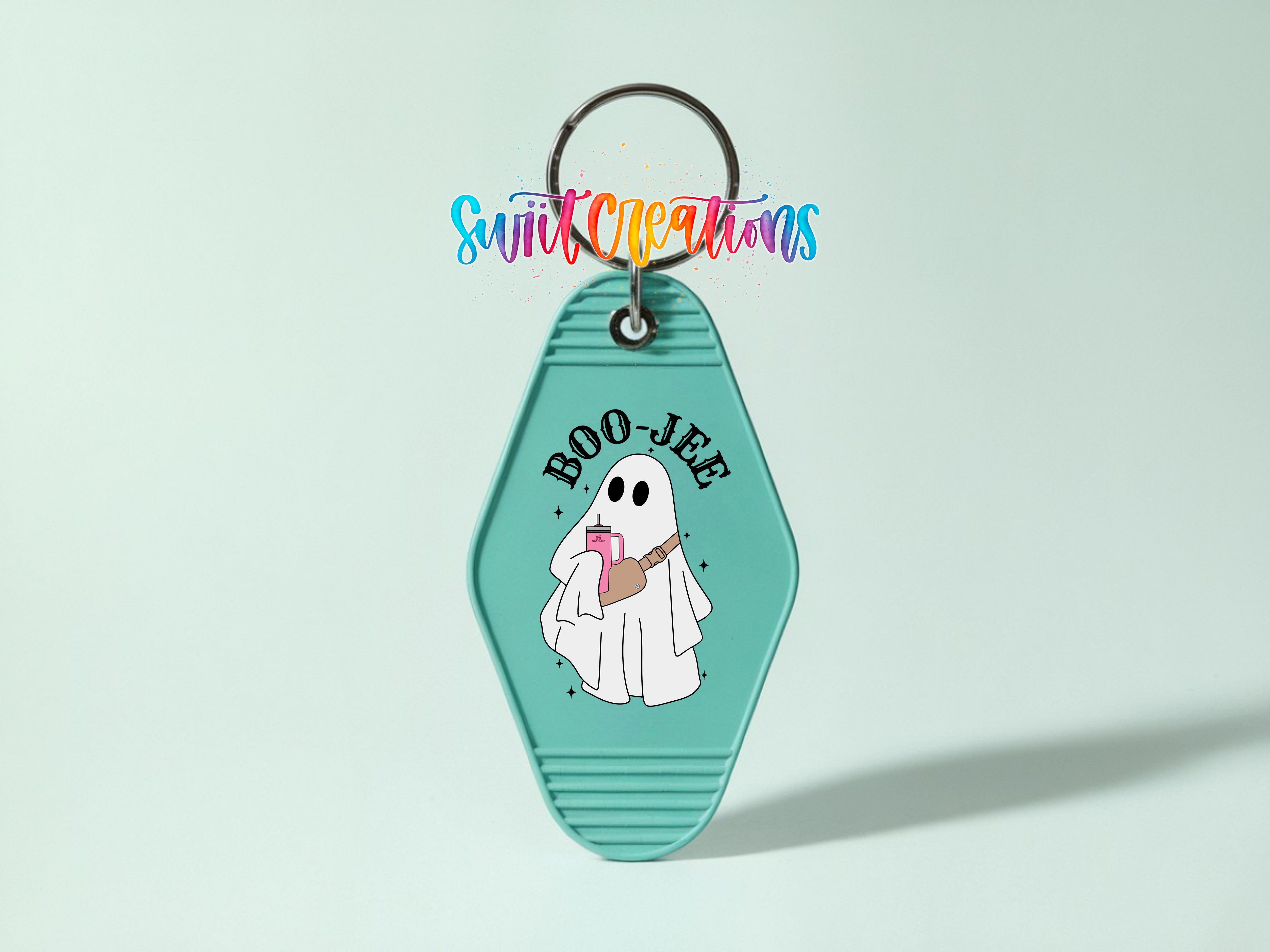 A keychain with a cartoon ghost holding a drink and the text "BOO JEE" printed on it.