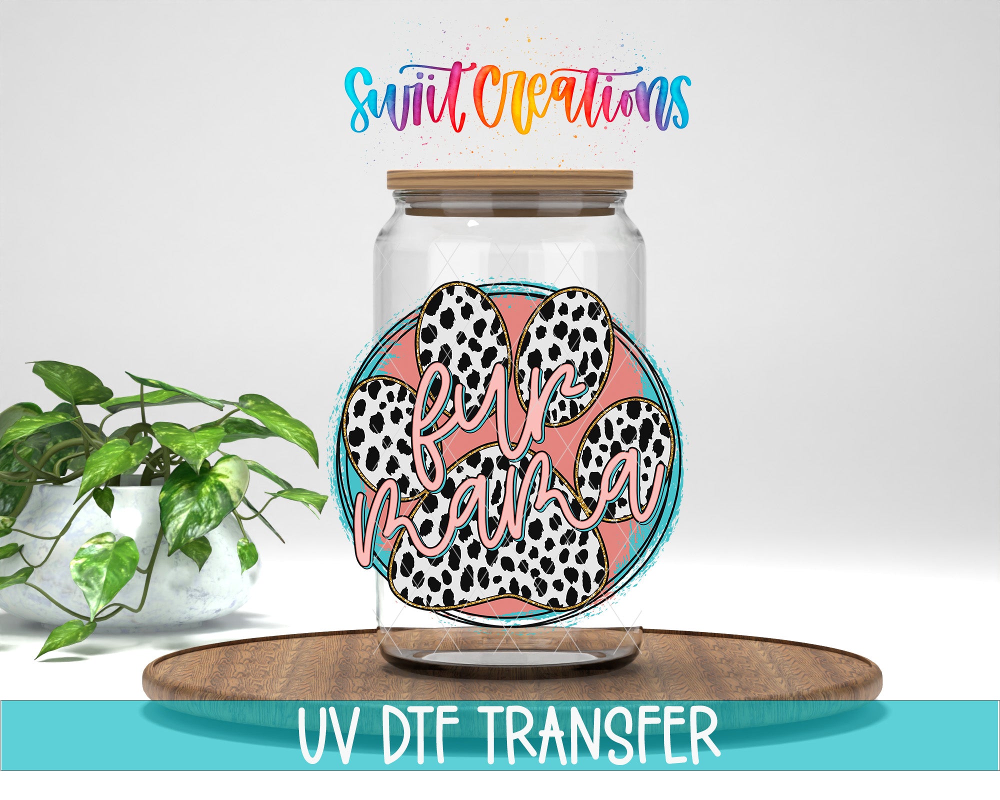 a glass jar with a paw print design, placed on a wooden surface. The jar has a lid and is surrounded by a potted plant. The text "Swift Creations" is written above the jar, and "UV DFT TRANSFER" is written below the jar.