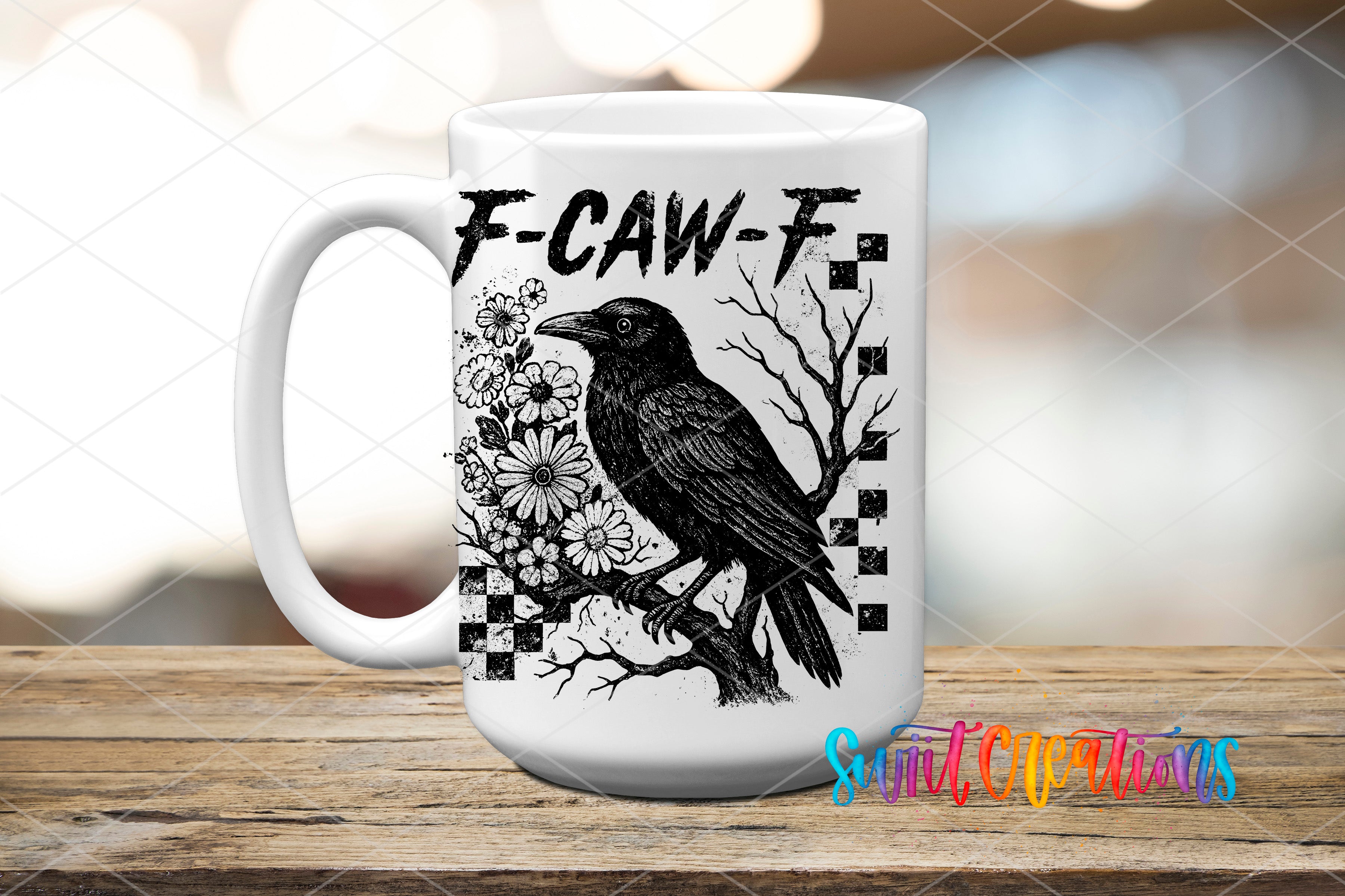 A white ceramic mug with a black and white illustration of a bird perched on a branch, surrounded by flowers and checkered patterns.