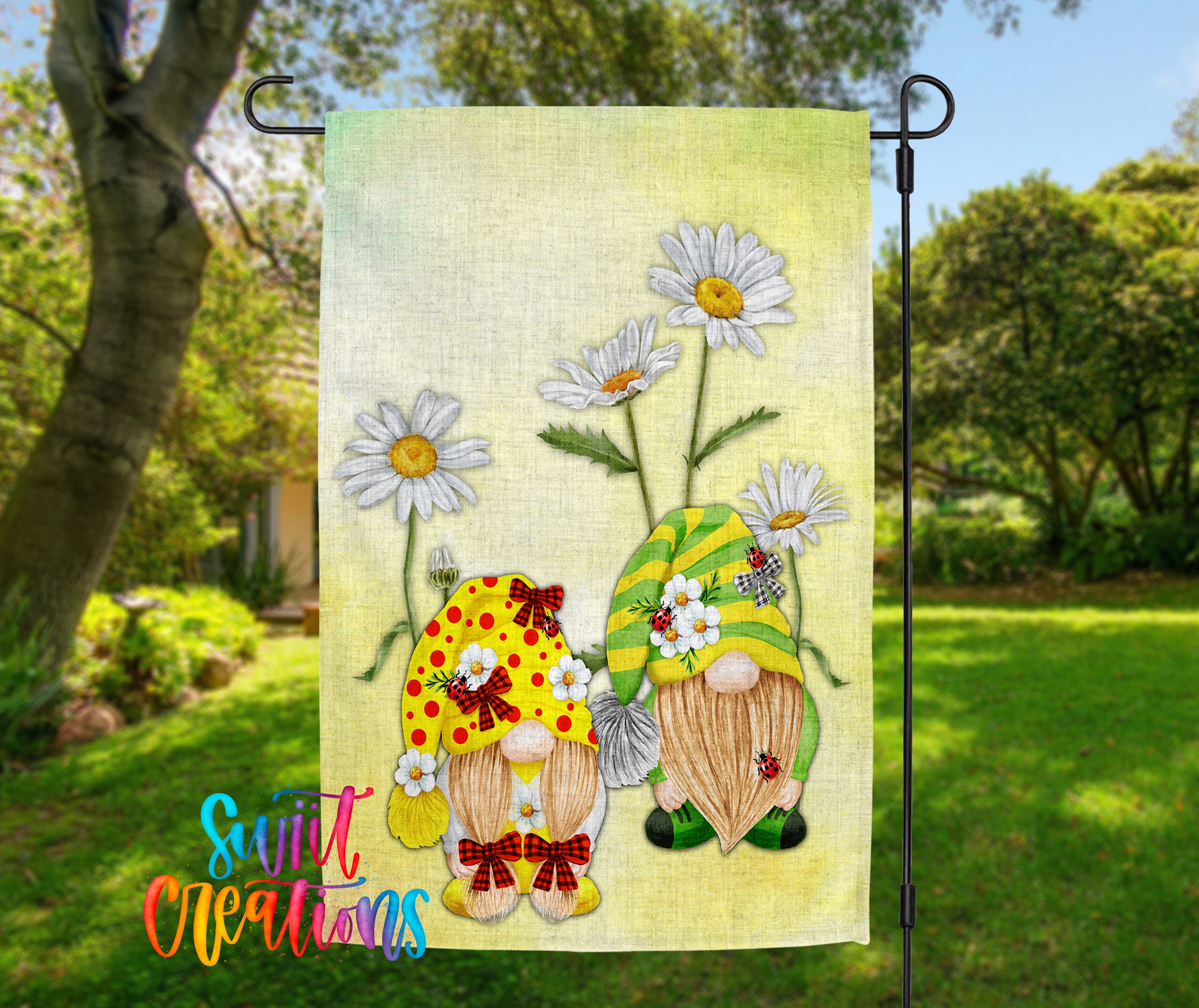 A garden gnome flag with a yellow and green gnome holding a bunch of white daisies, set against a background of trees and greenery.